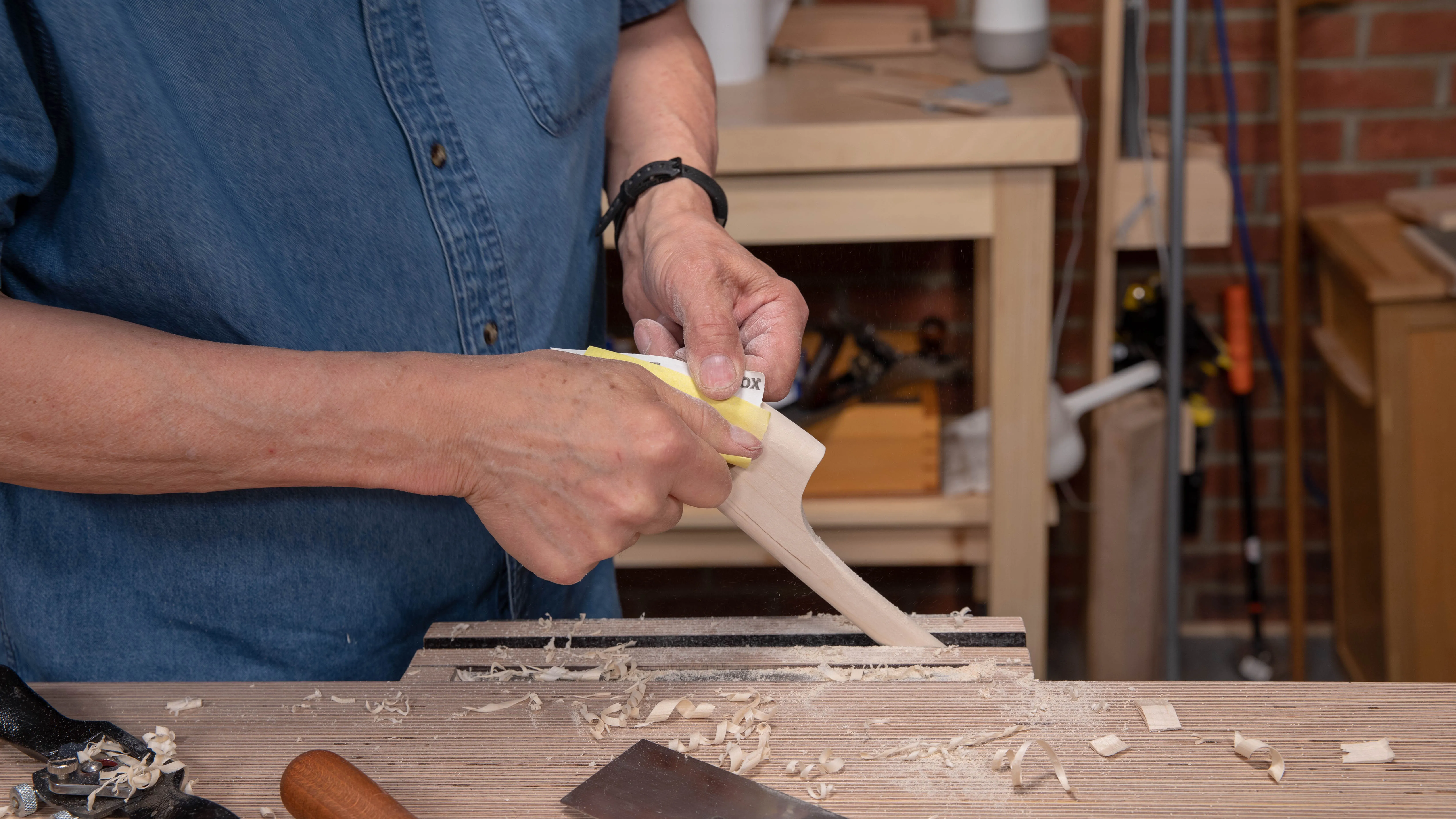 Sand with 120 grit sandpaper to even out any flats or ridges
