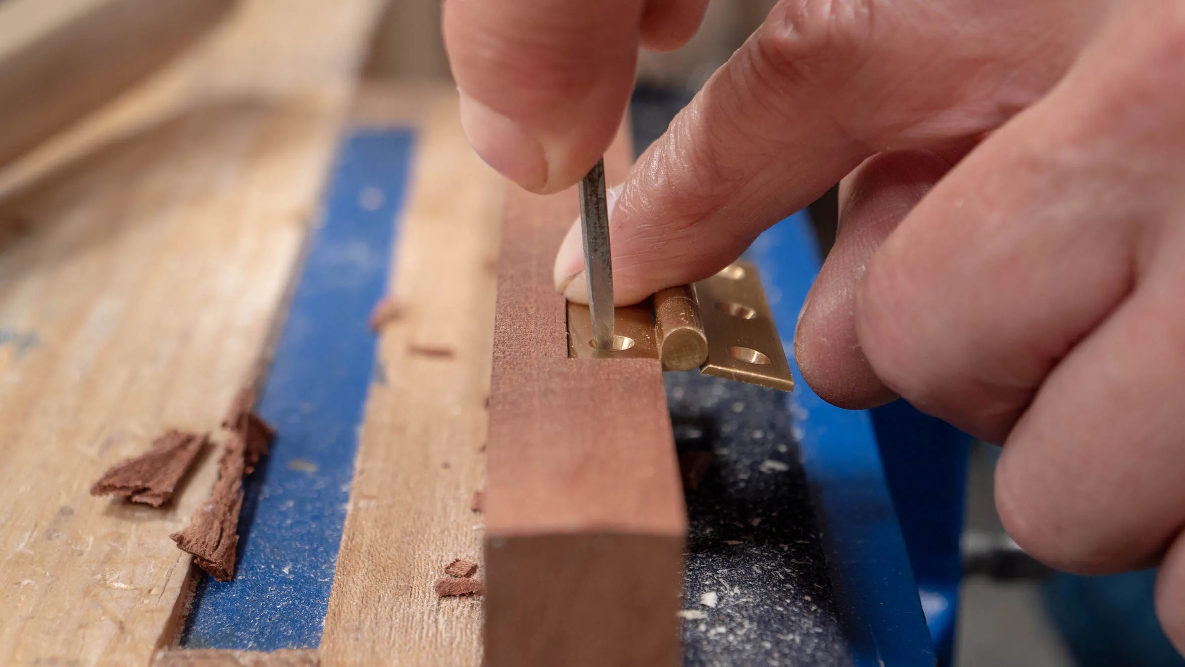 Use the awl towards the back edge of the hole