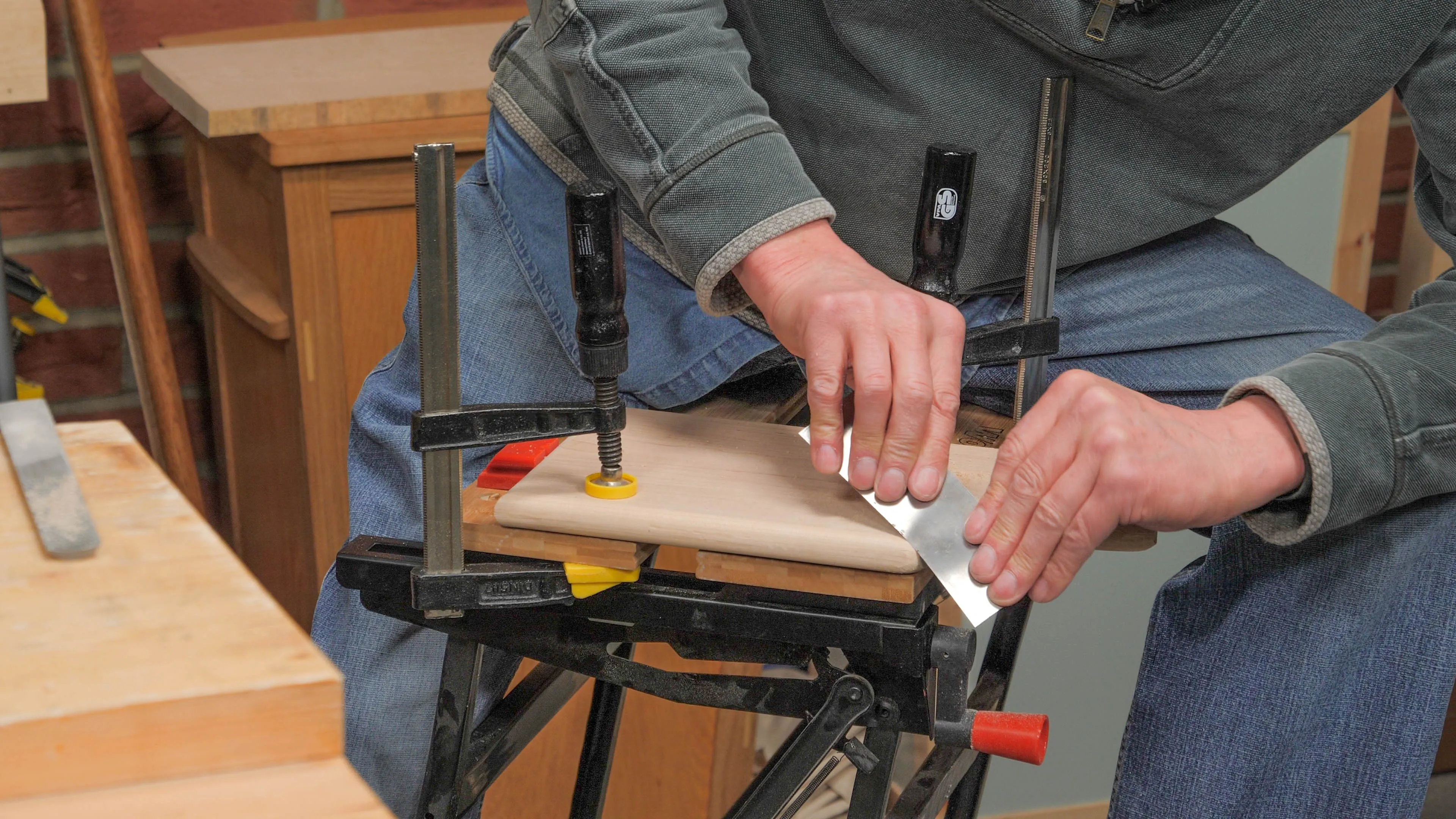 Refine with a sharp card scraper, bending a little to match the contour