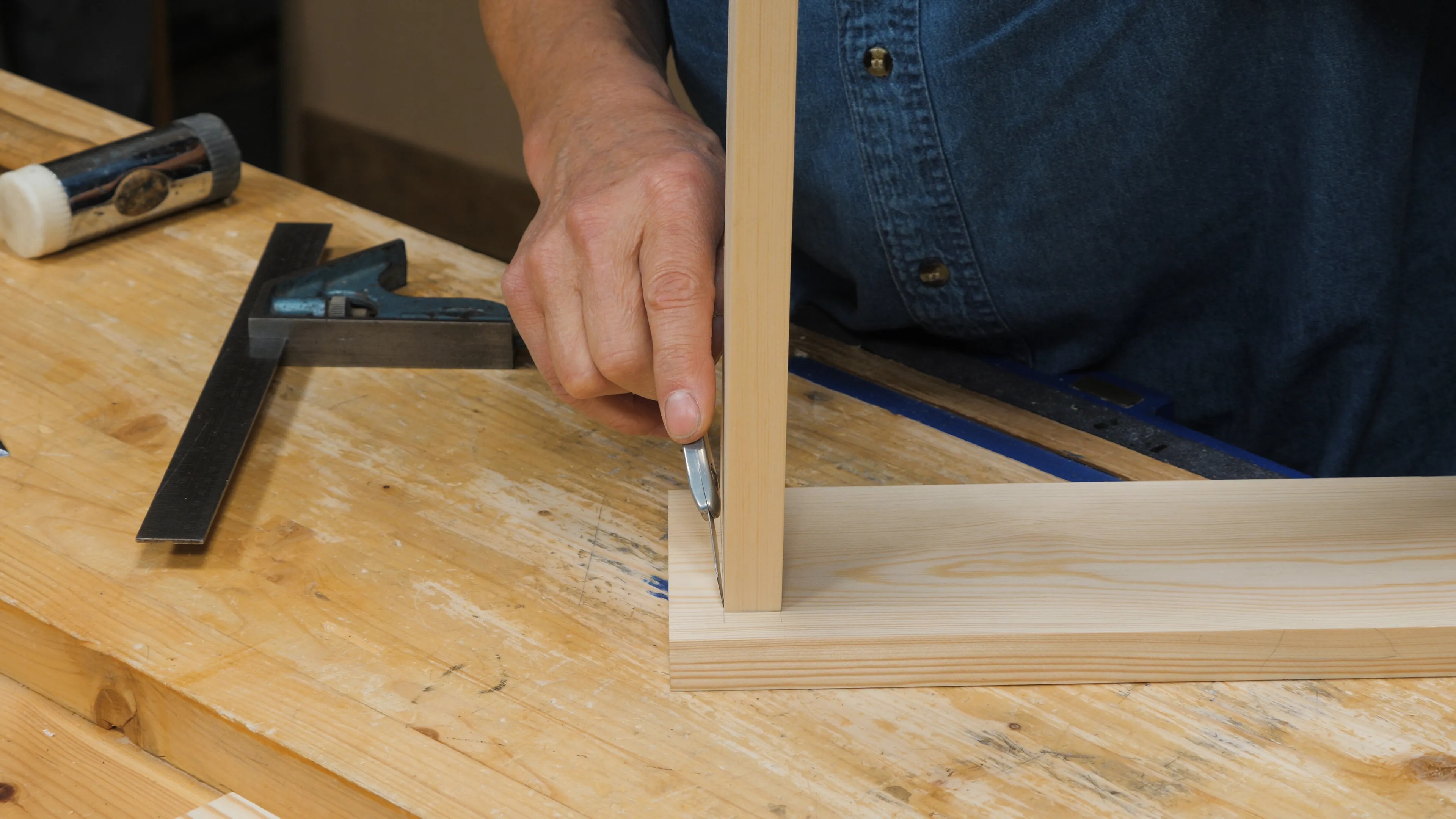 Butt the side piece up against the first wall to mark the second with a small knife nick