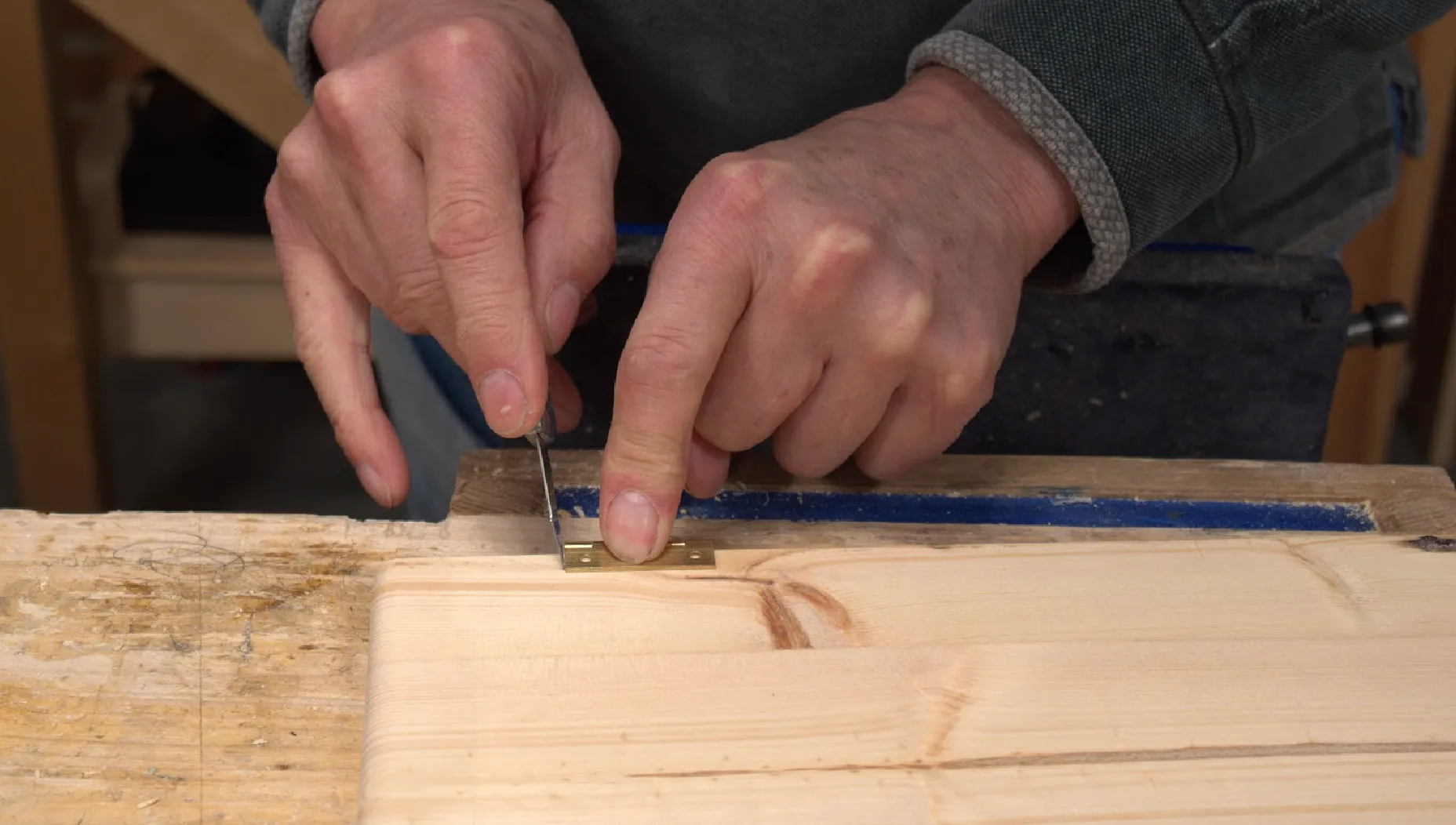 Align the hinge with the pencil line and make a knifewall across both the ends of the hinge
