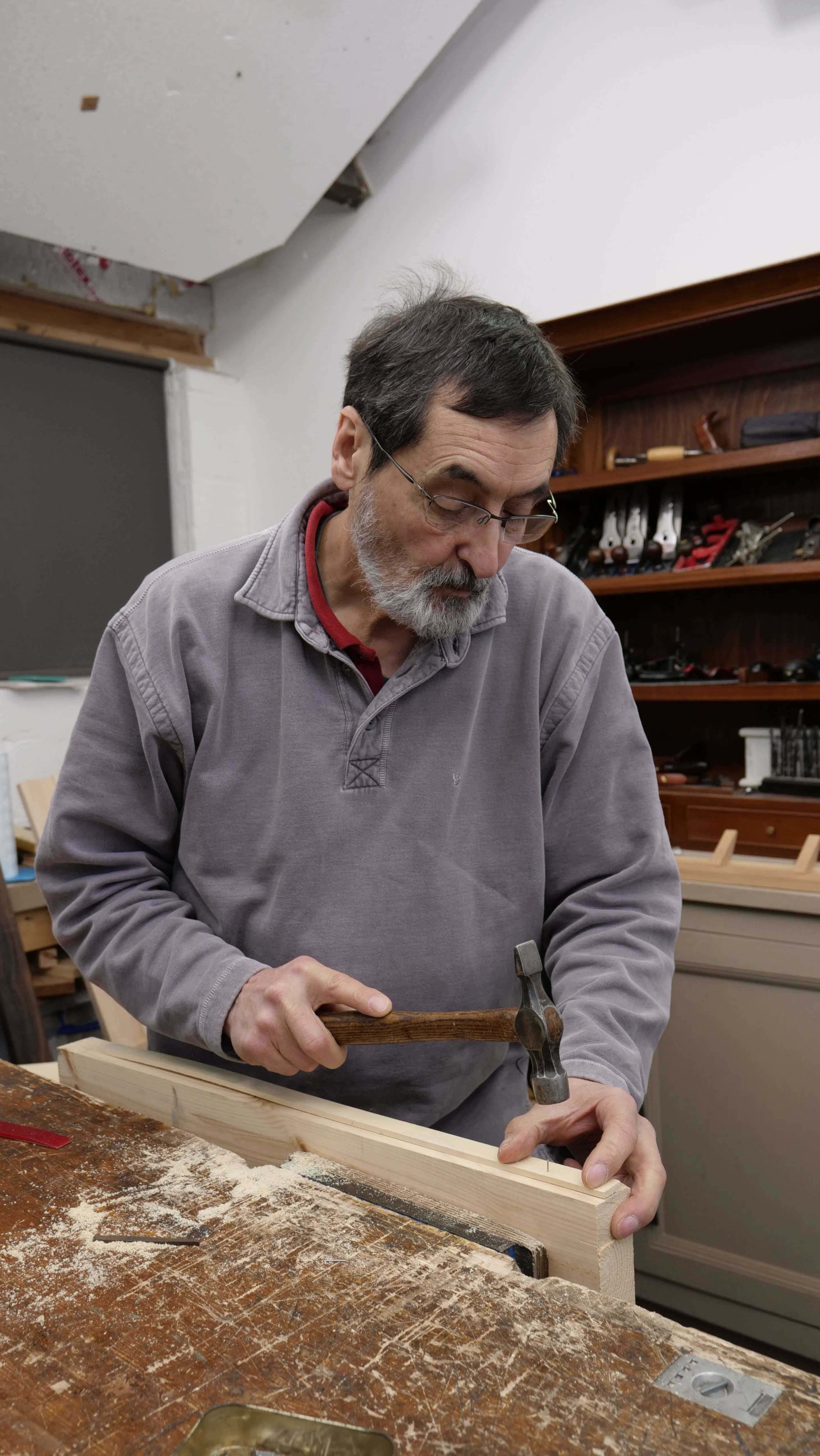 Once the nail can support itself, use the rounded face of the hammer with larger strikes to drive it into the wood