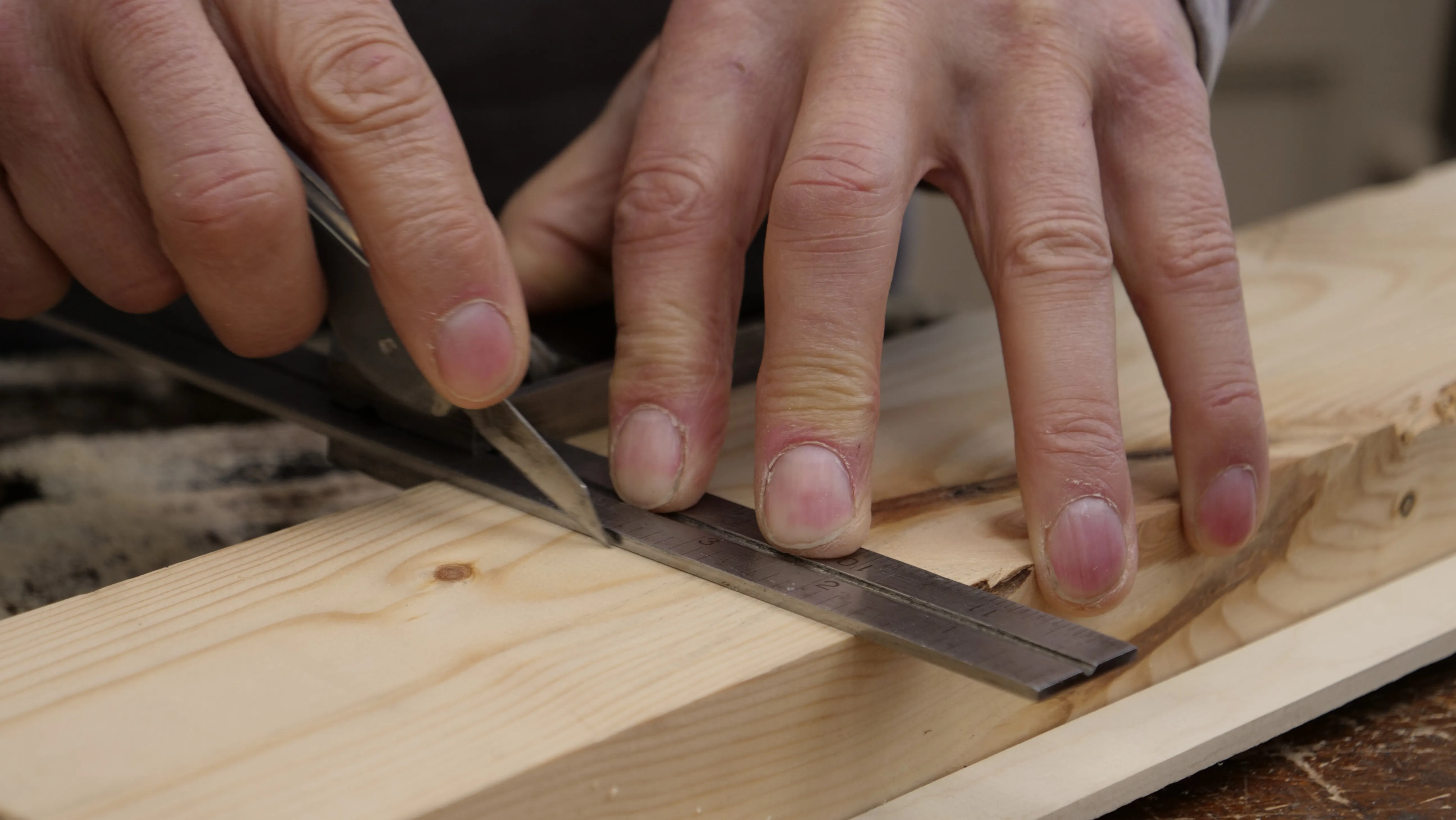 Use your non- dominant hand to hold the beam across your wood, with one or two fingers on the stock to hold it in position