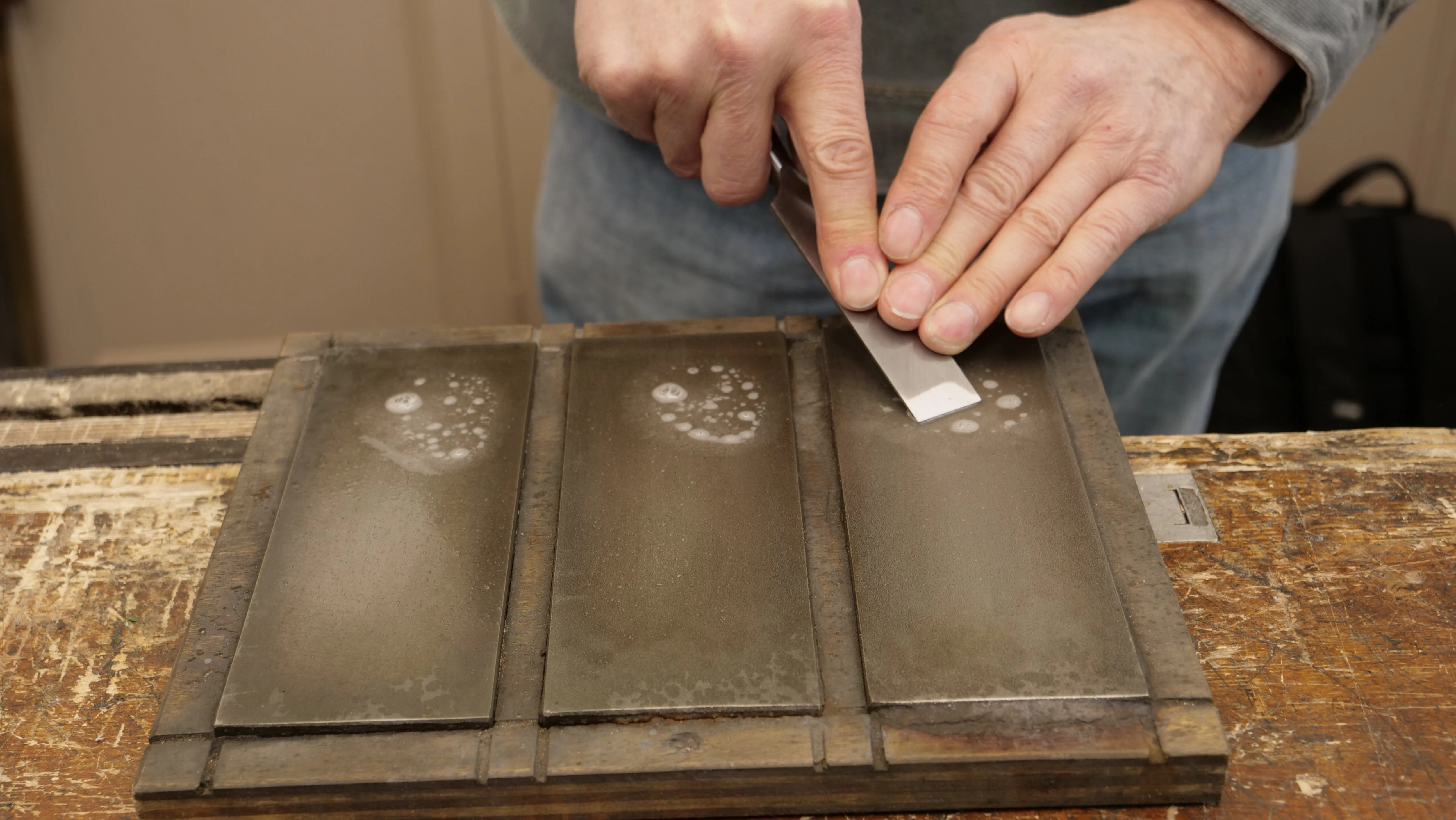 Use the most coarse of the diamond plates. Start at a 30 degree angle and as you push the chisel away from you, you will naturally end at a 20-25 degree angle, perfect for creating a camber.