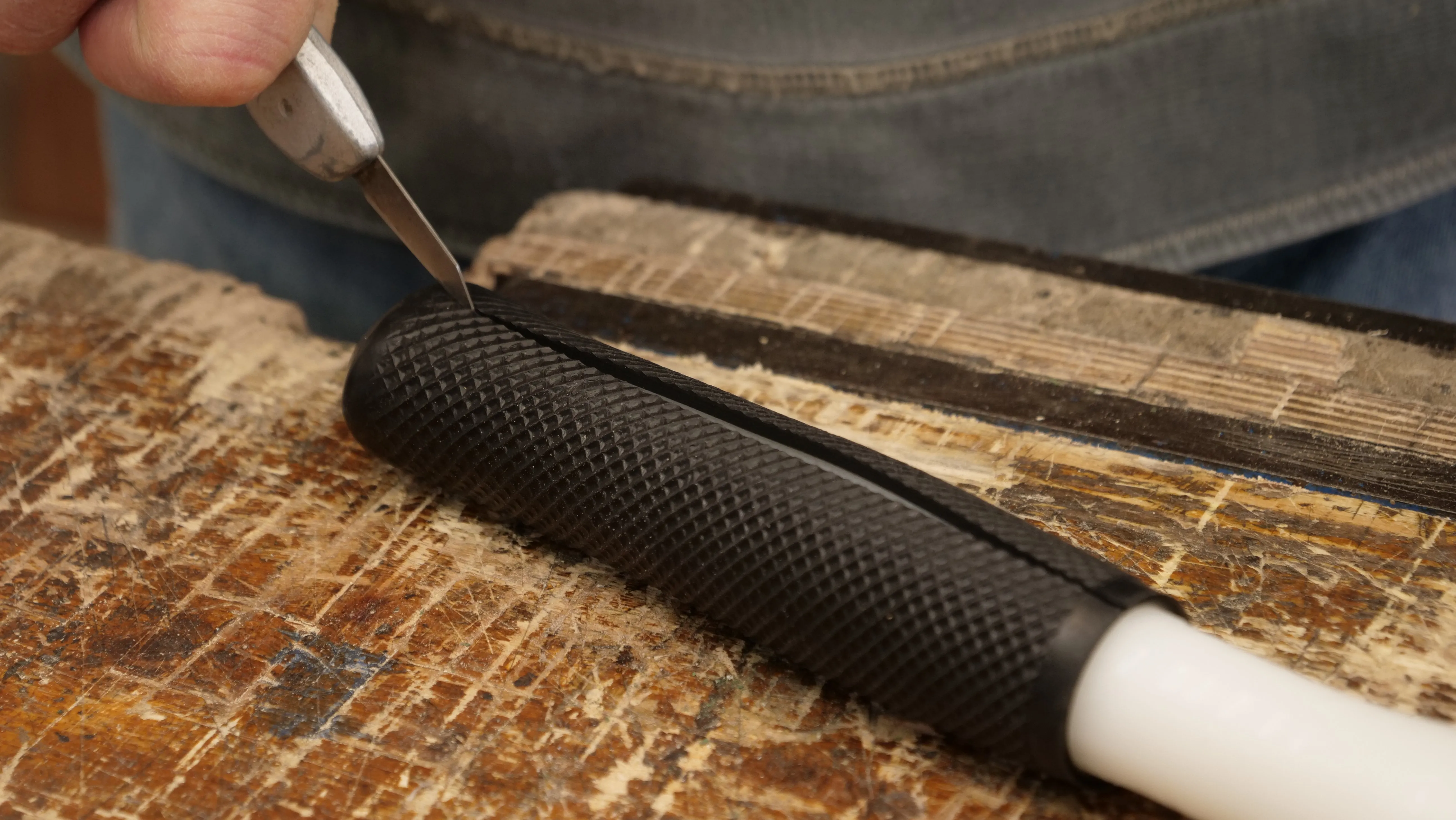 Cut off the rubber handle using a knife. This rubberised sleeving reduces sensitivity in use.