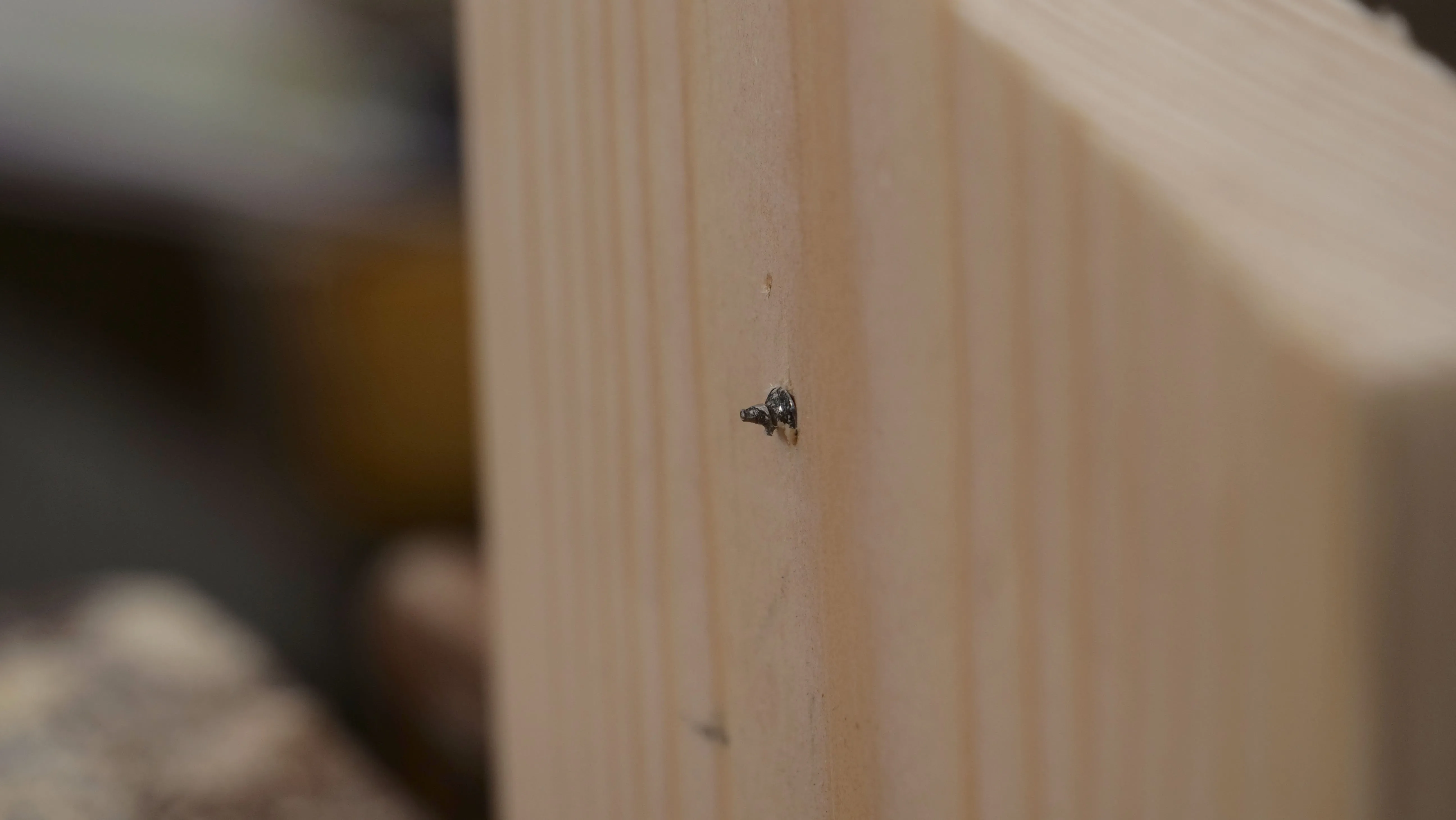 The sharp spur poking through the other side, this is the point you should turn the wood around and go in from the other side to stop splitting and tearing