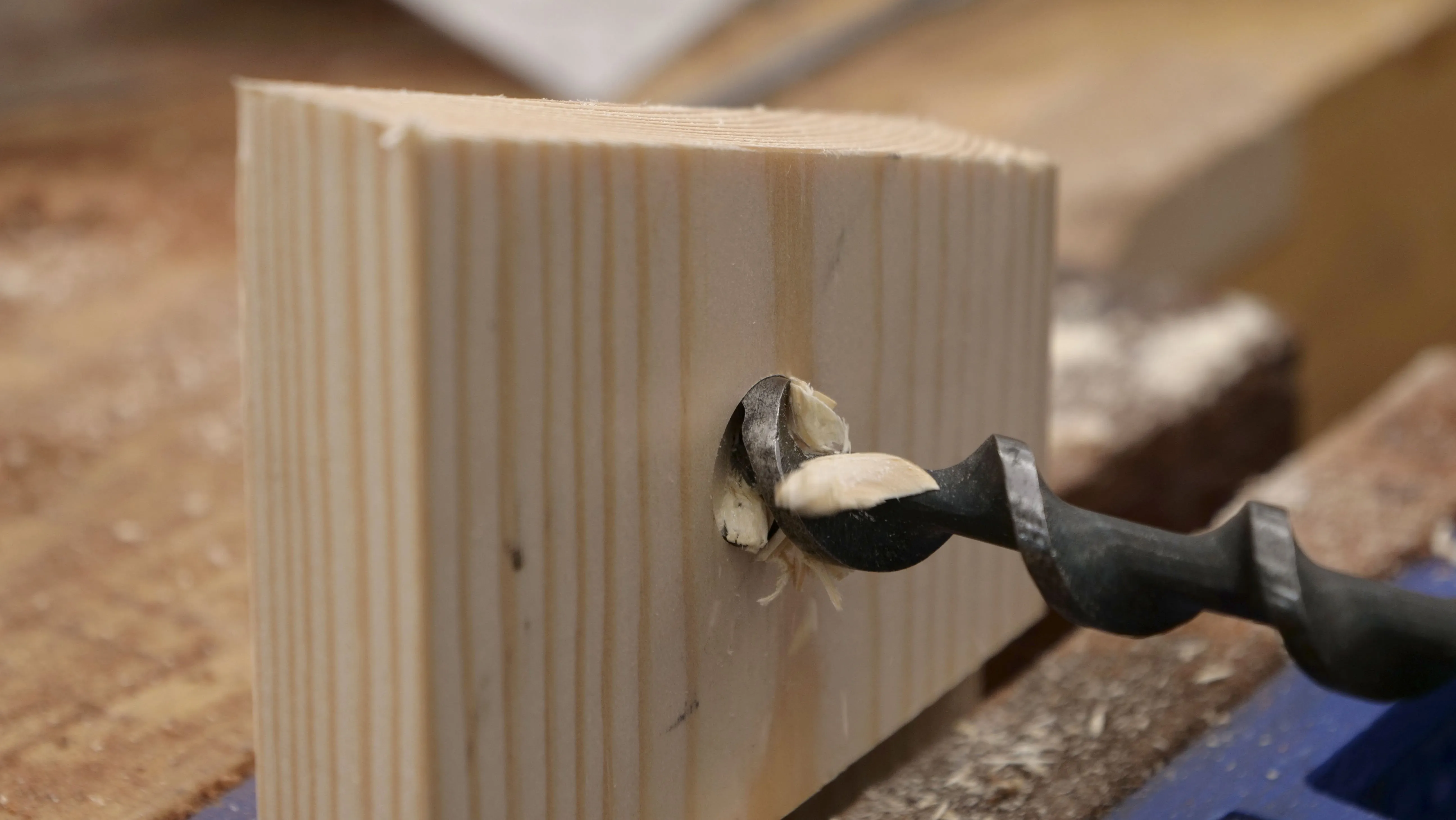By not continuing to bore from one side, you will avoid splitting the wood when the bit is fully through