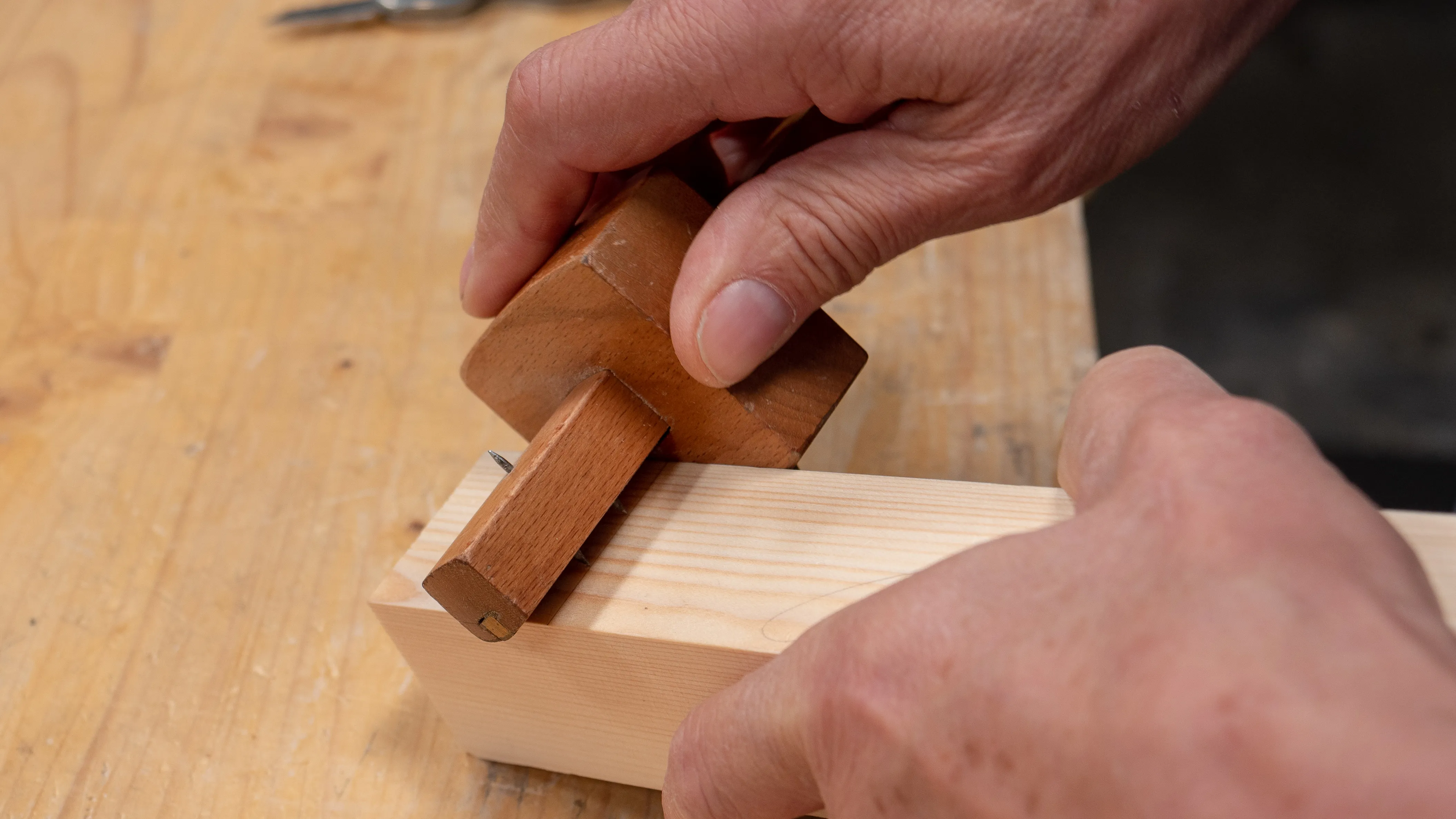 Run the gauge along one edge, always applying firm lateral pressure to keep the stock registered flat