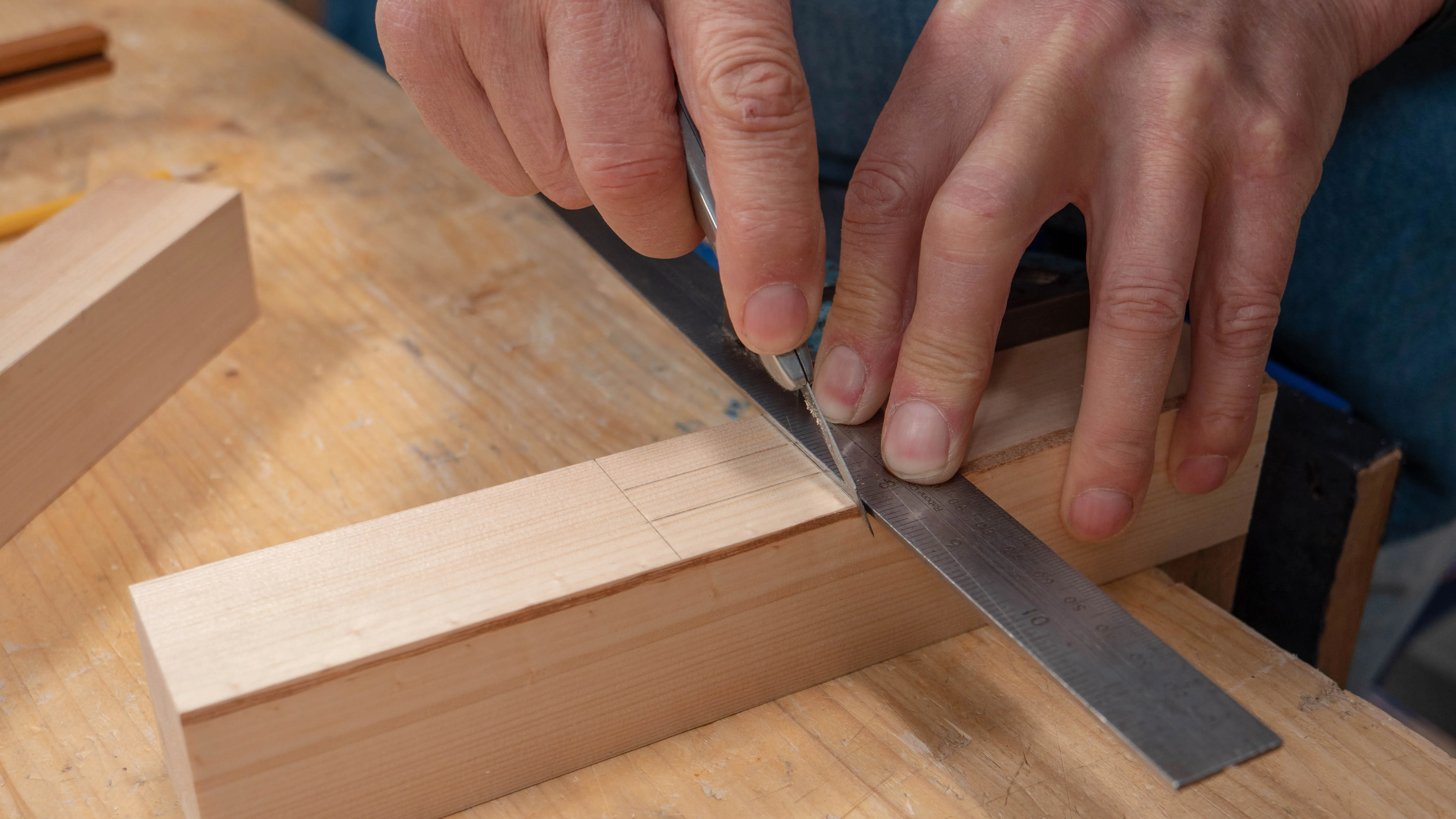 Make a nick on the corner, keeping the stock of the square against the registration face