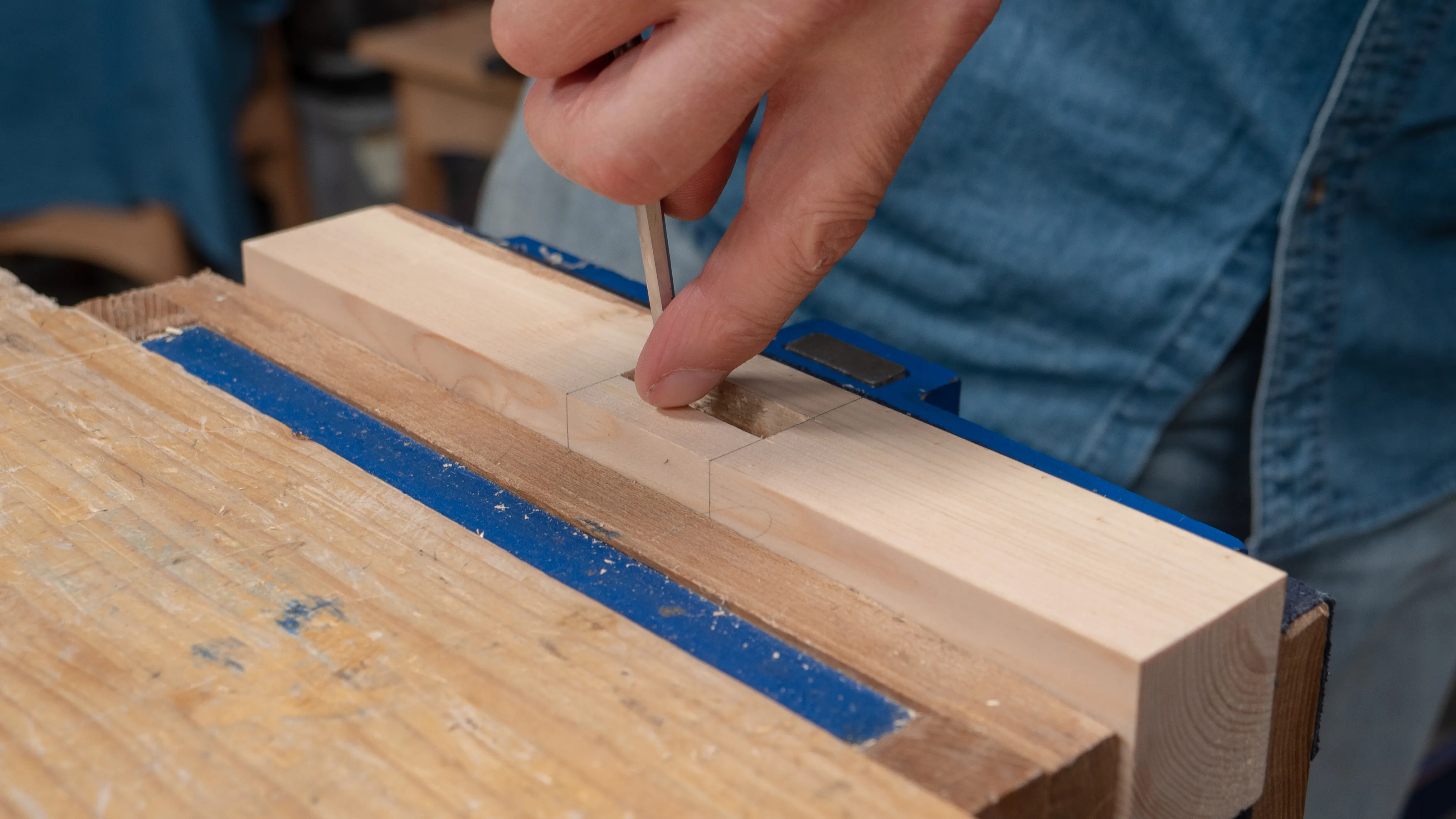 Use your finger to mark on the chisel how deep the hole is at