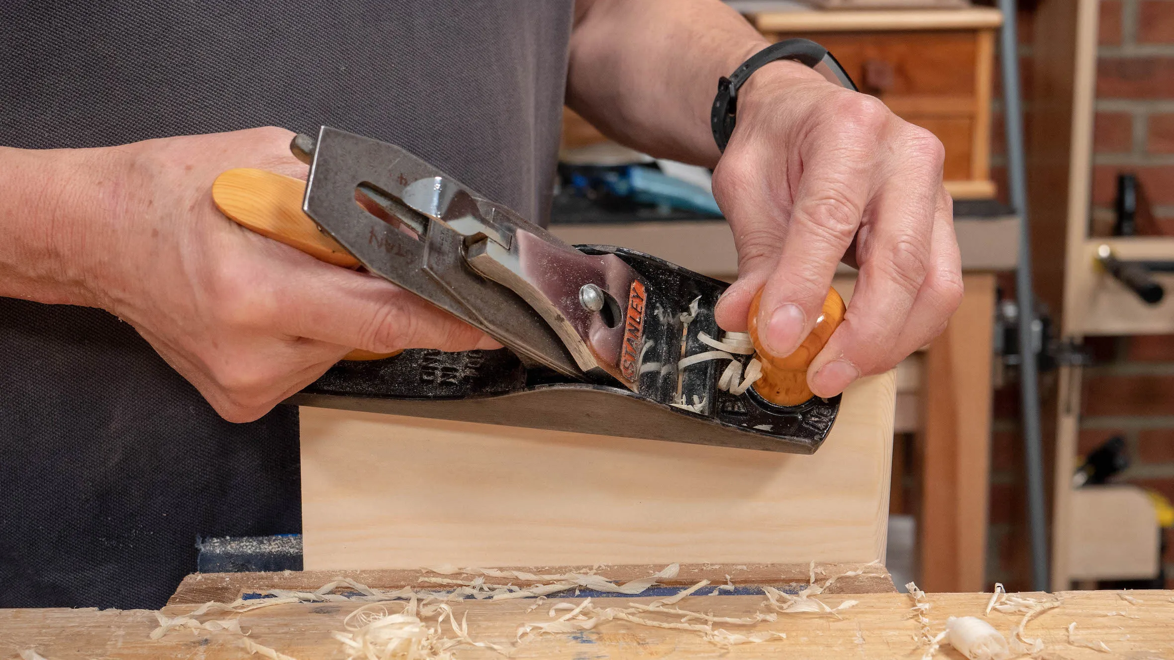 The hand position should be light and used as a guide, not to apply downwards pressure