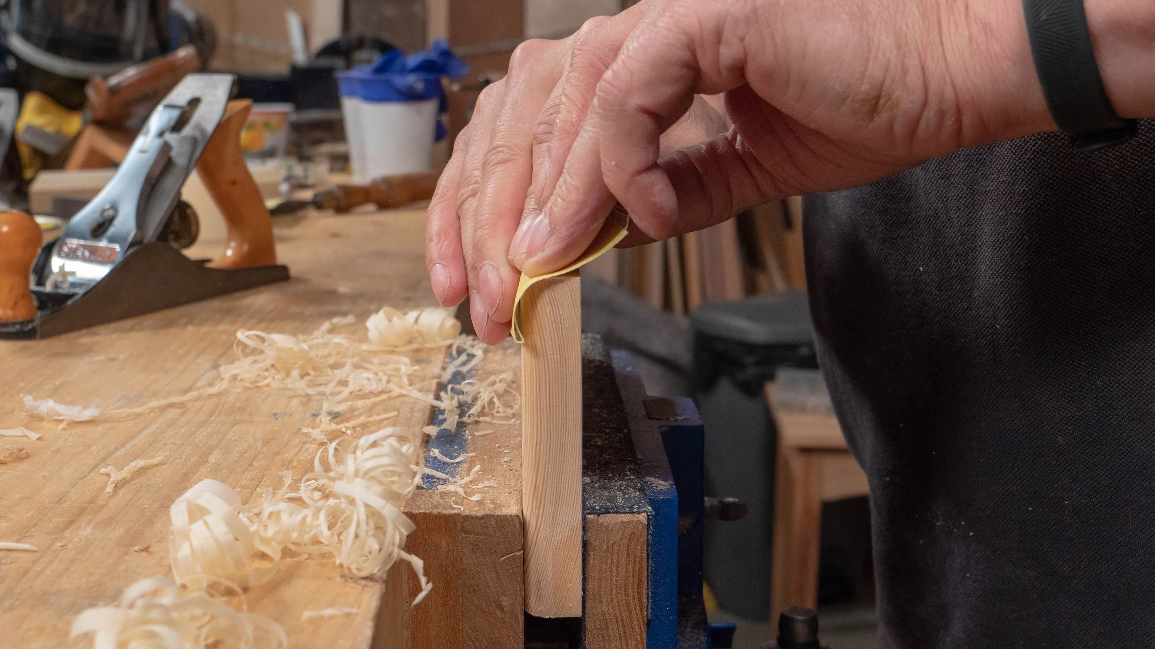 You don't need a sanding block, just use your fingers and they will mould the paper to the shape of the roundover