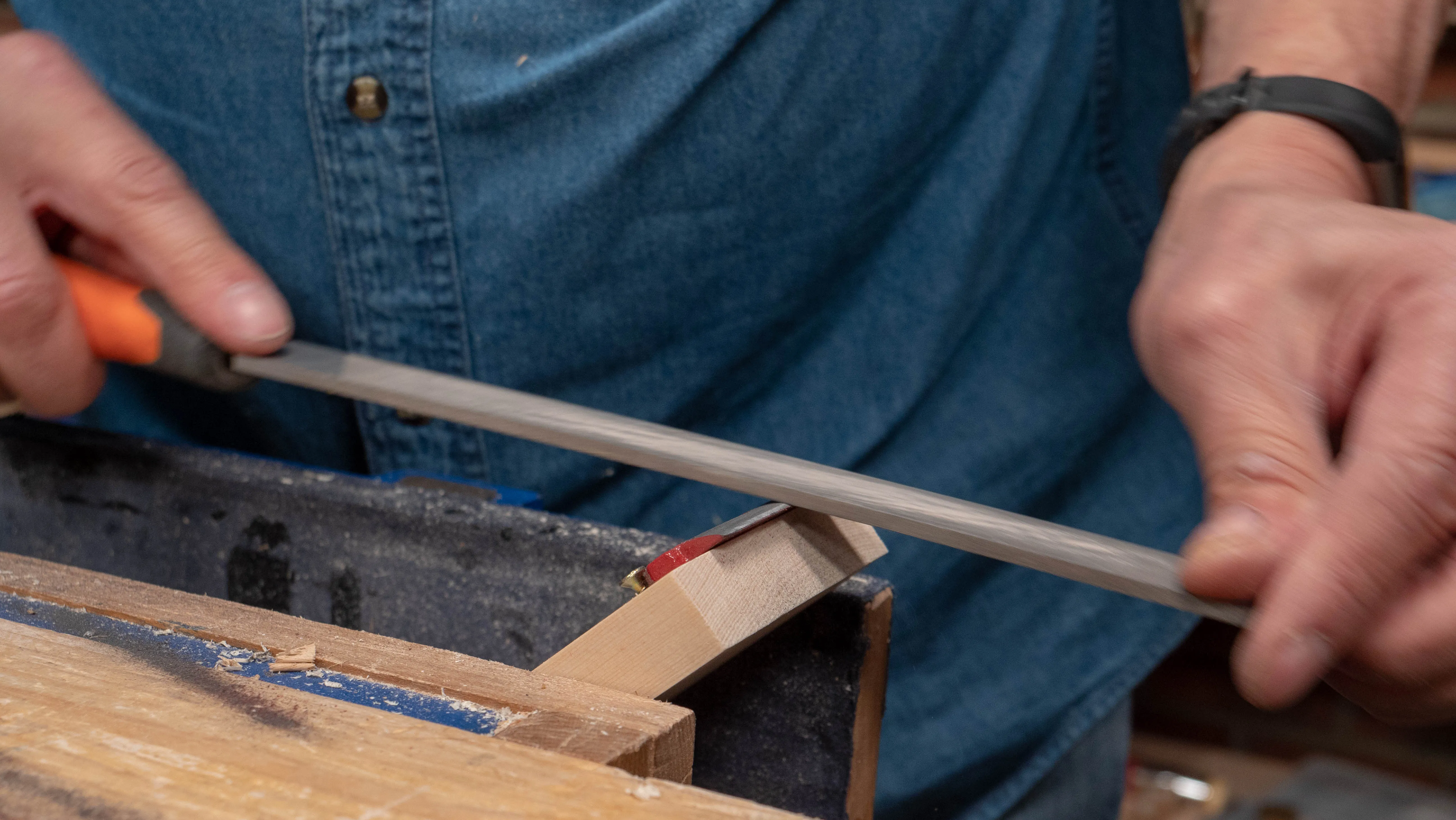 Angle the wood in the vise to create a camber on the edge of the cap iron