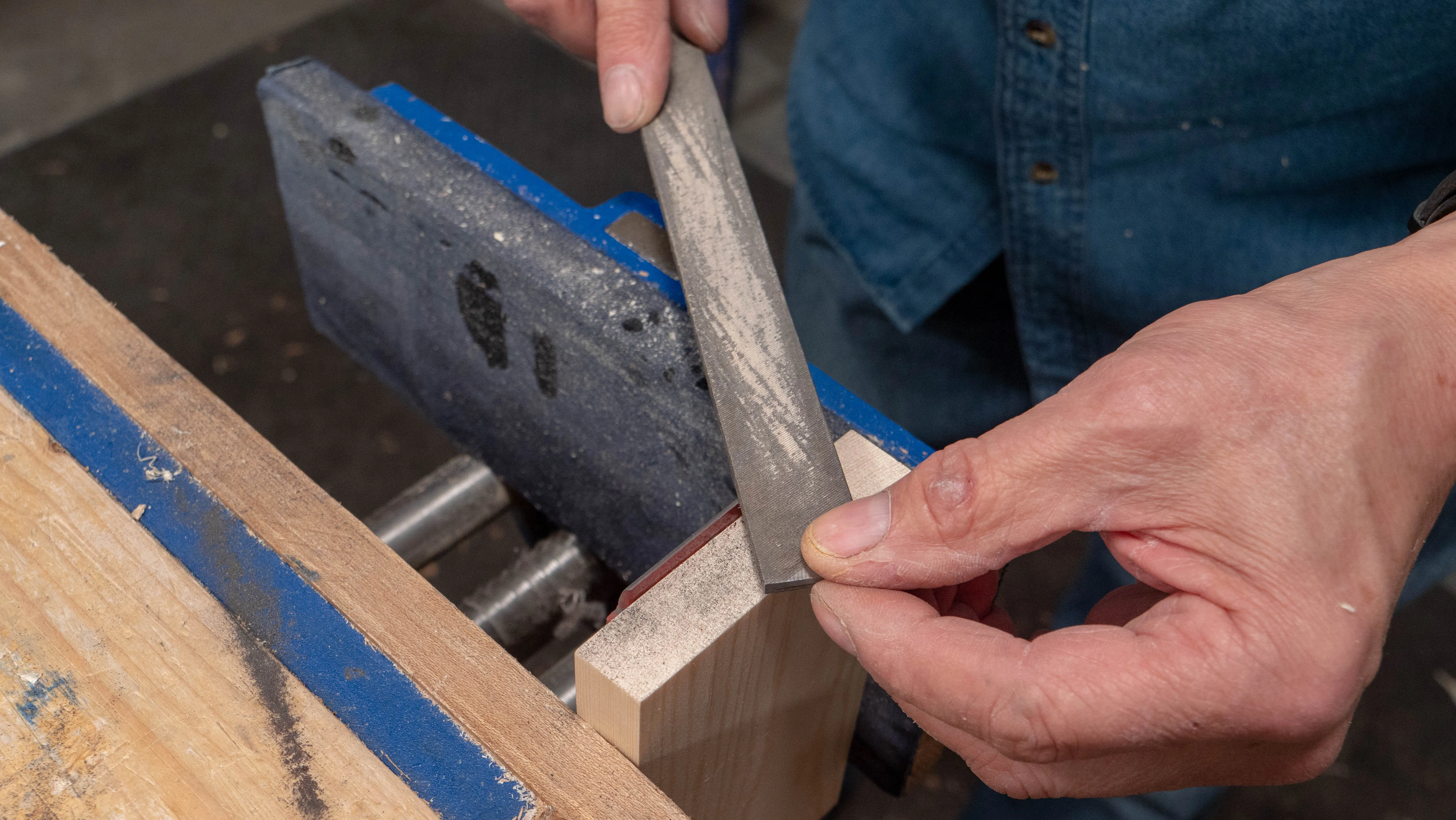 Position the wood vertically in the vise, draw file along the edge of the cap iron