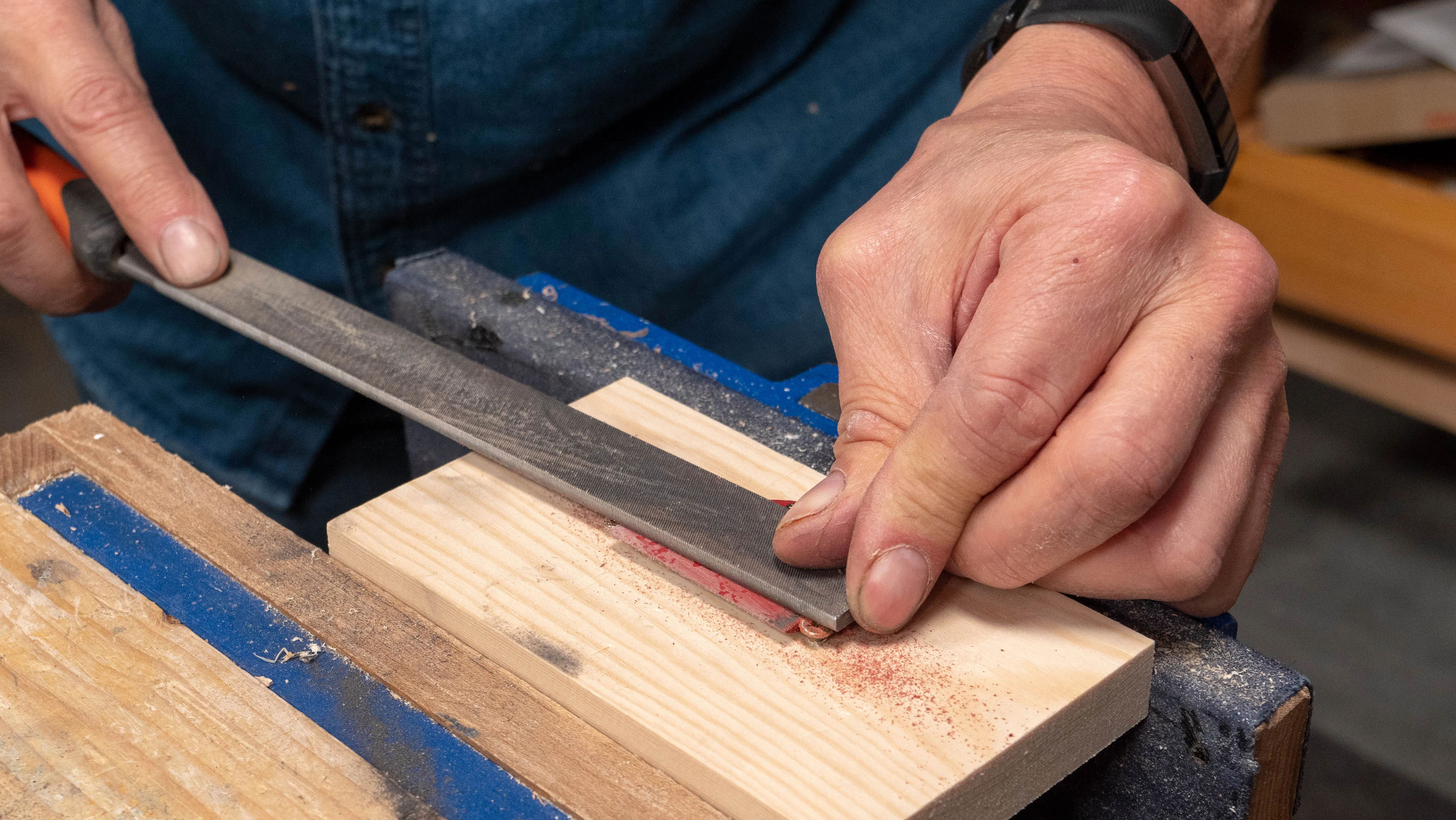 Use the file with one hand on the handle and one hand applying pressure over the cap iron