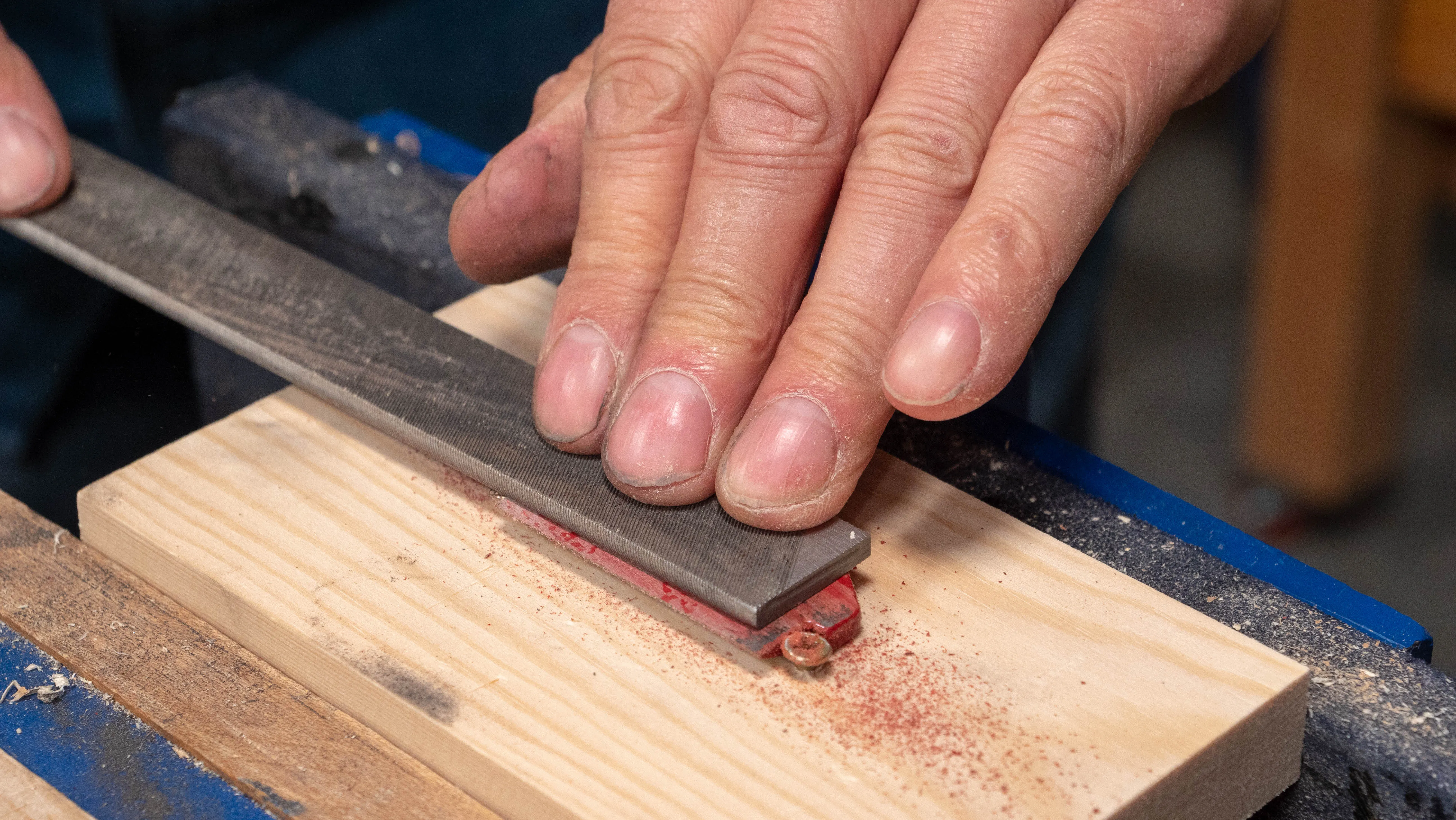 Use the file with one hand on the handle and one hand applying pressure over the cap iron