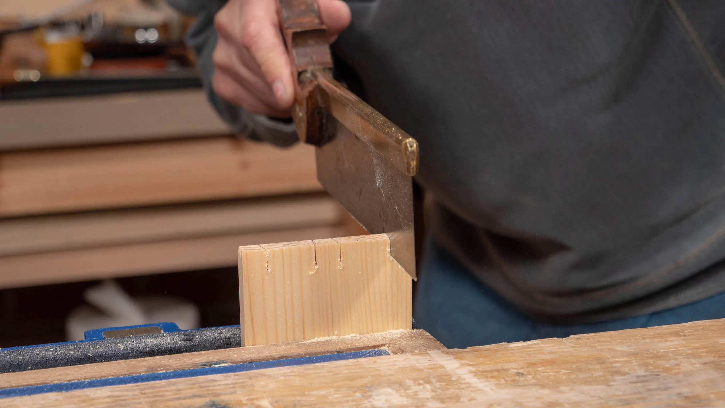 Saw down the sides of the pins, stopping just above the depth line