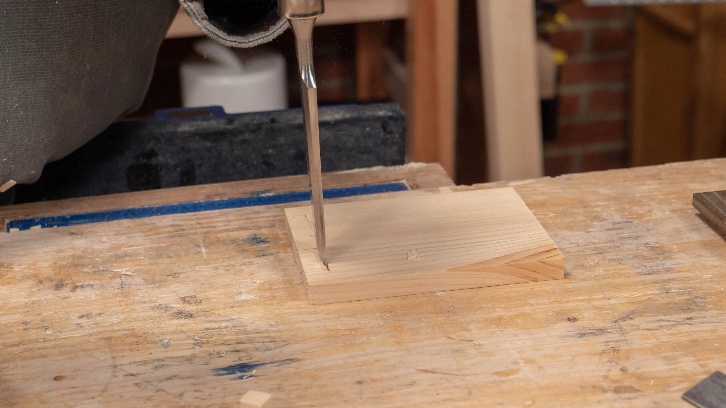 Begin to chop with a wide chisel but do not hit too hard at this point