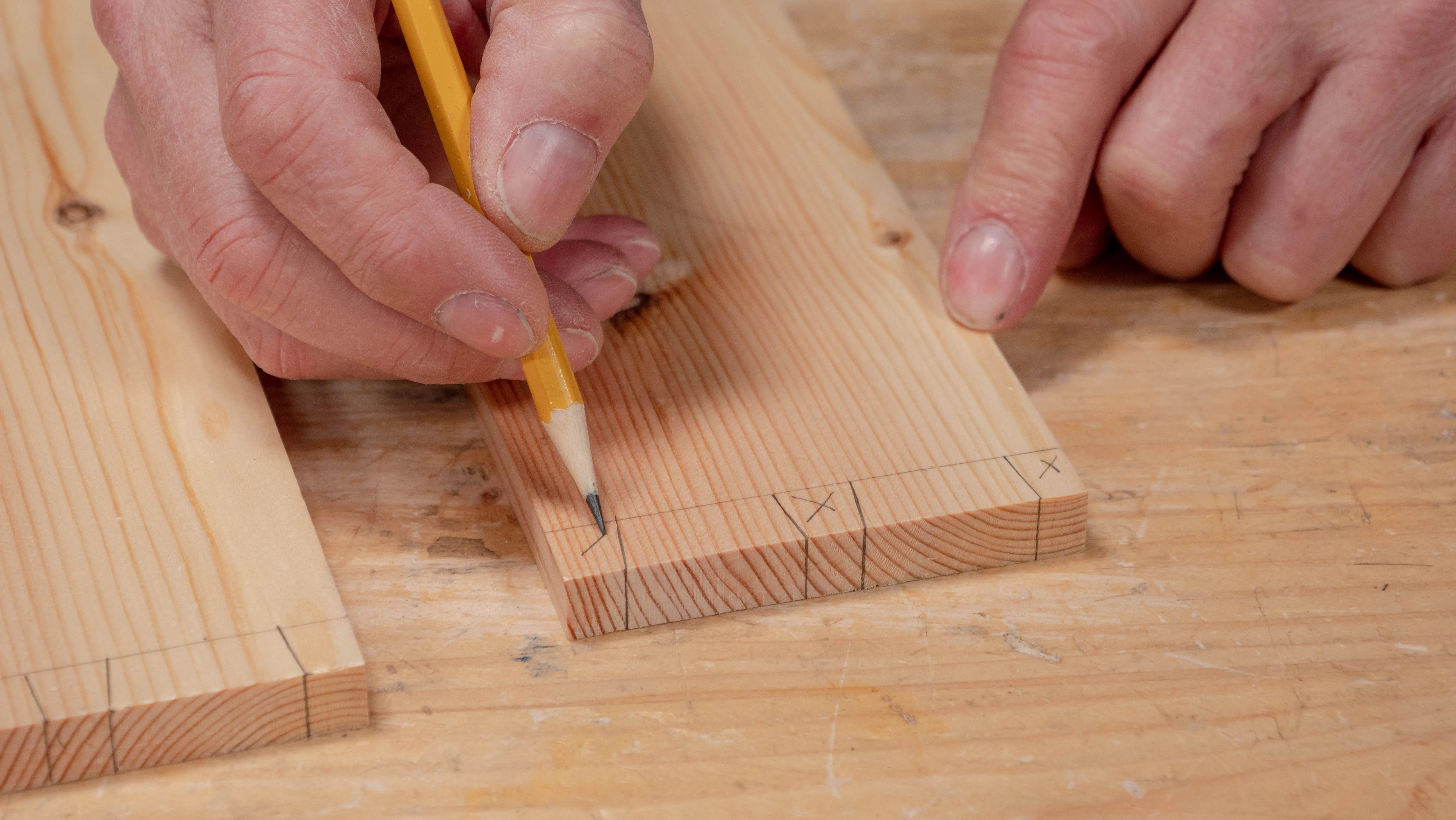 Mark the pin pieces (waste to remove) with an 'X'