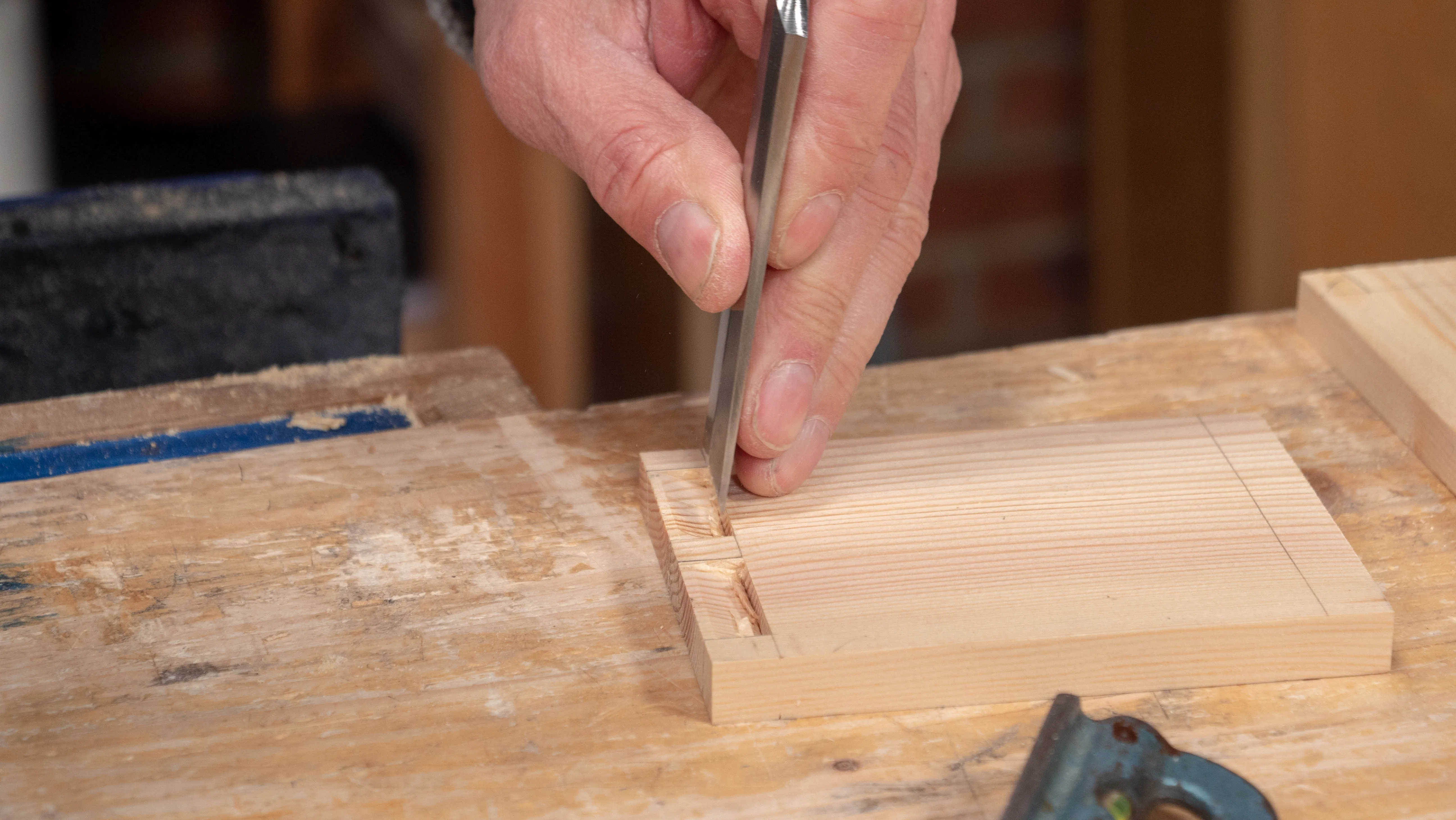 Chop the tail recesses with a wide chisel from both sides