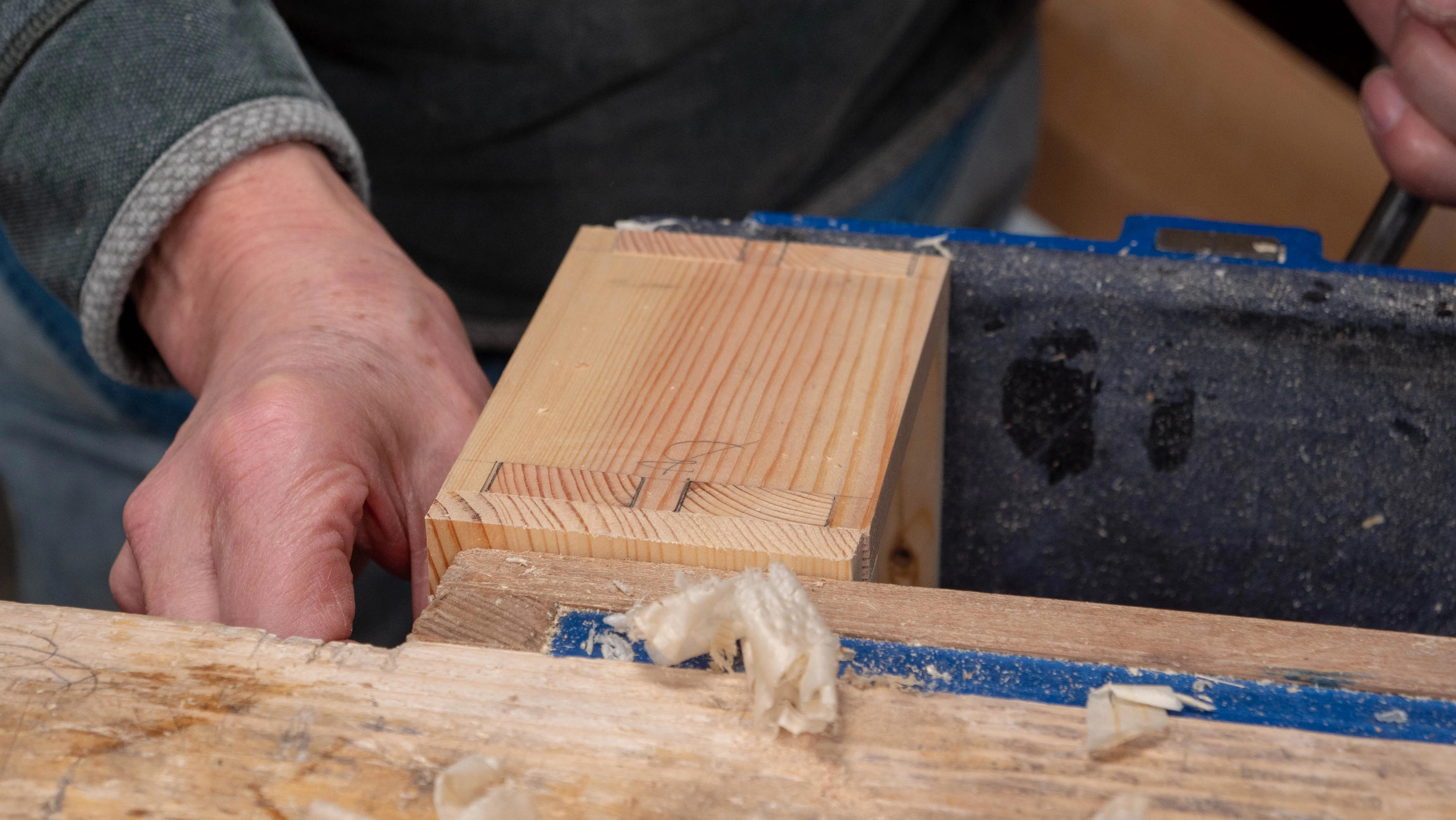 Clamp a sacrificial piece between the box and the bench end of the vise