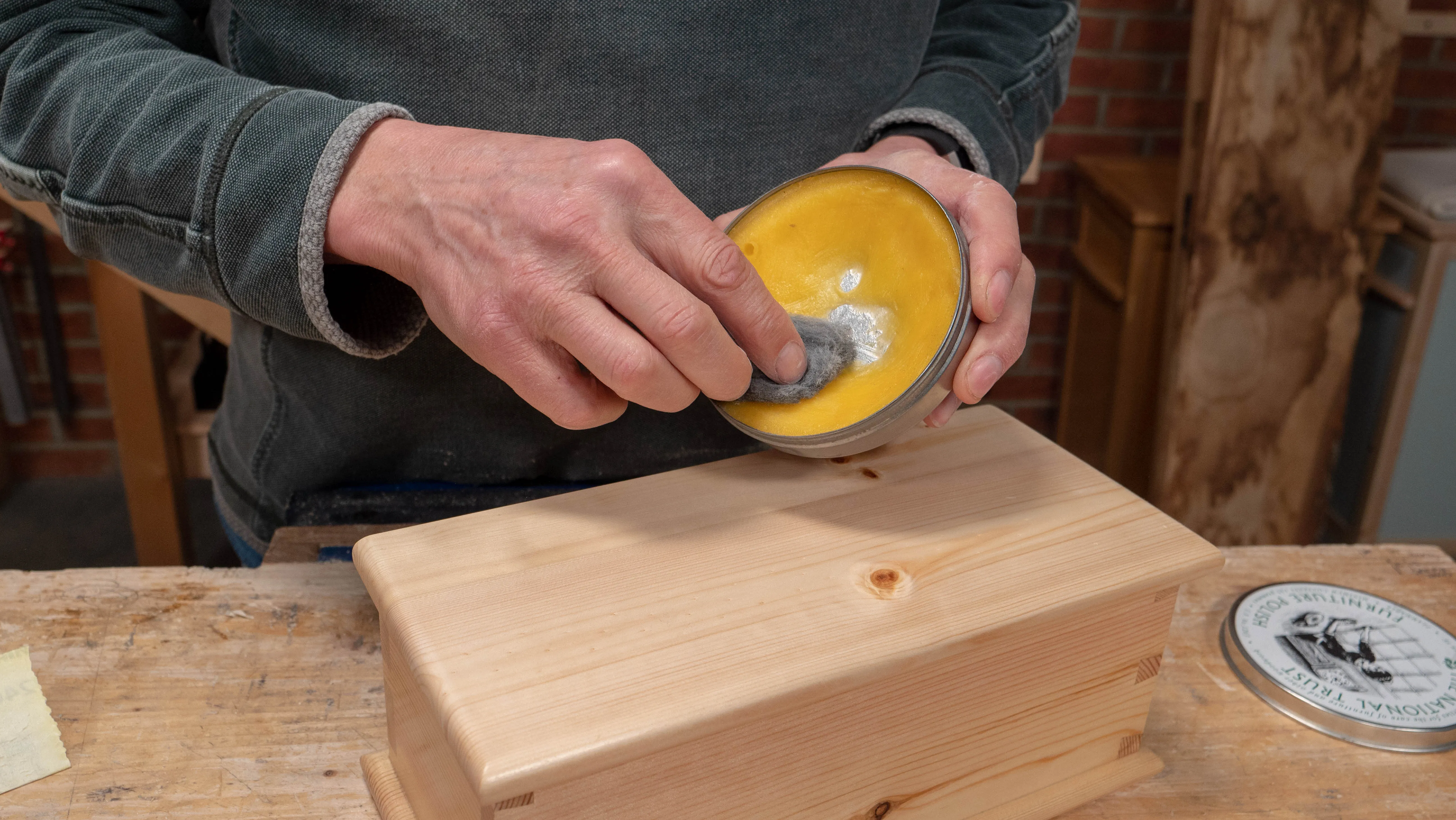 Apply soft wax polish with super fine steel wool