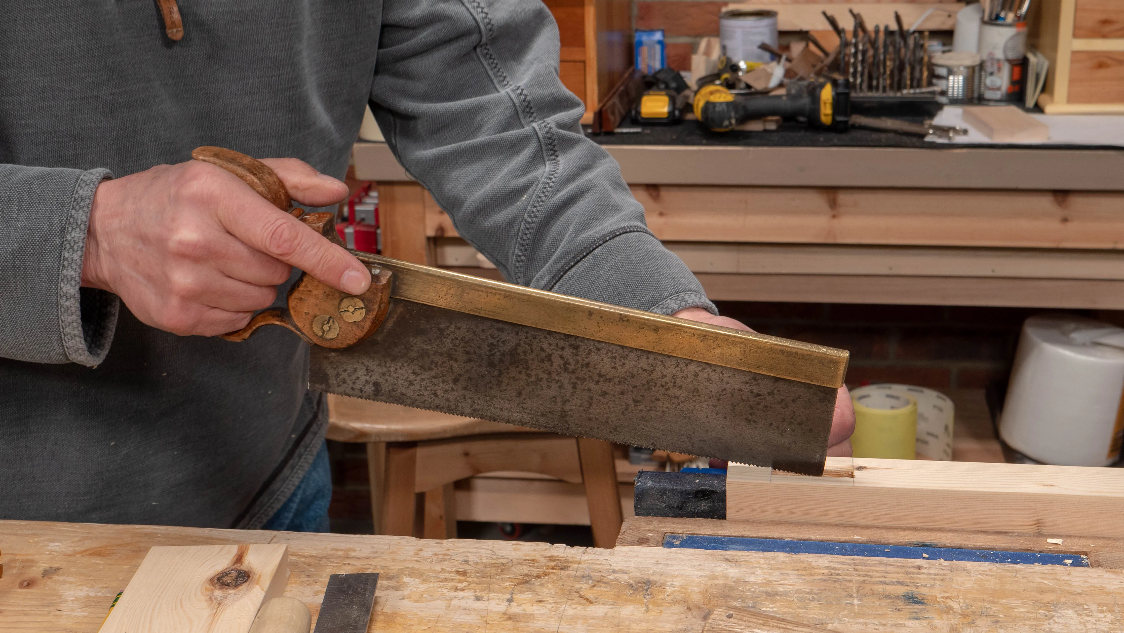 Saw down the two gauge lines using the internal faces of the mortise hole as a guide