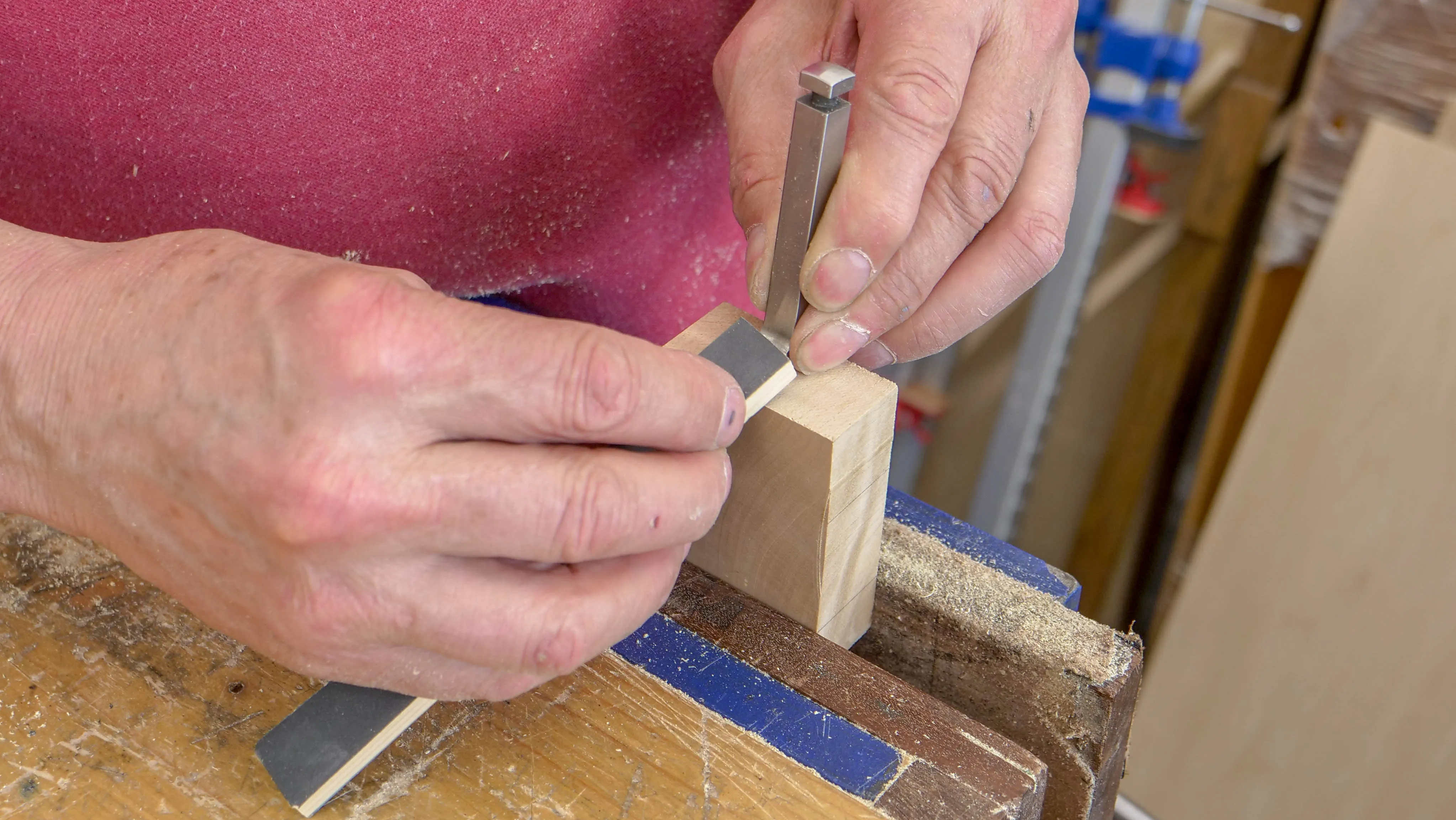 Place a piece of wood into the vise, wide enough to balance the blade on and high enough that the paddle sits at the right angle against the blade