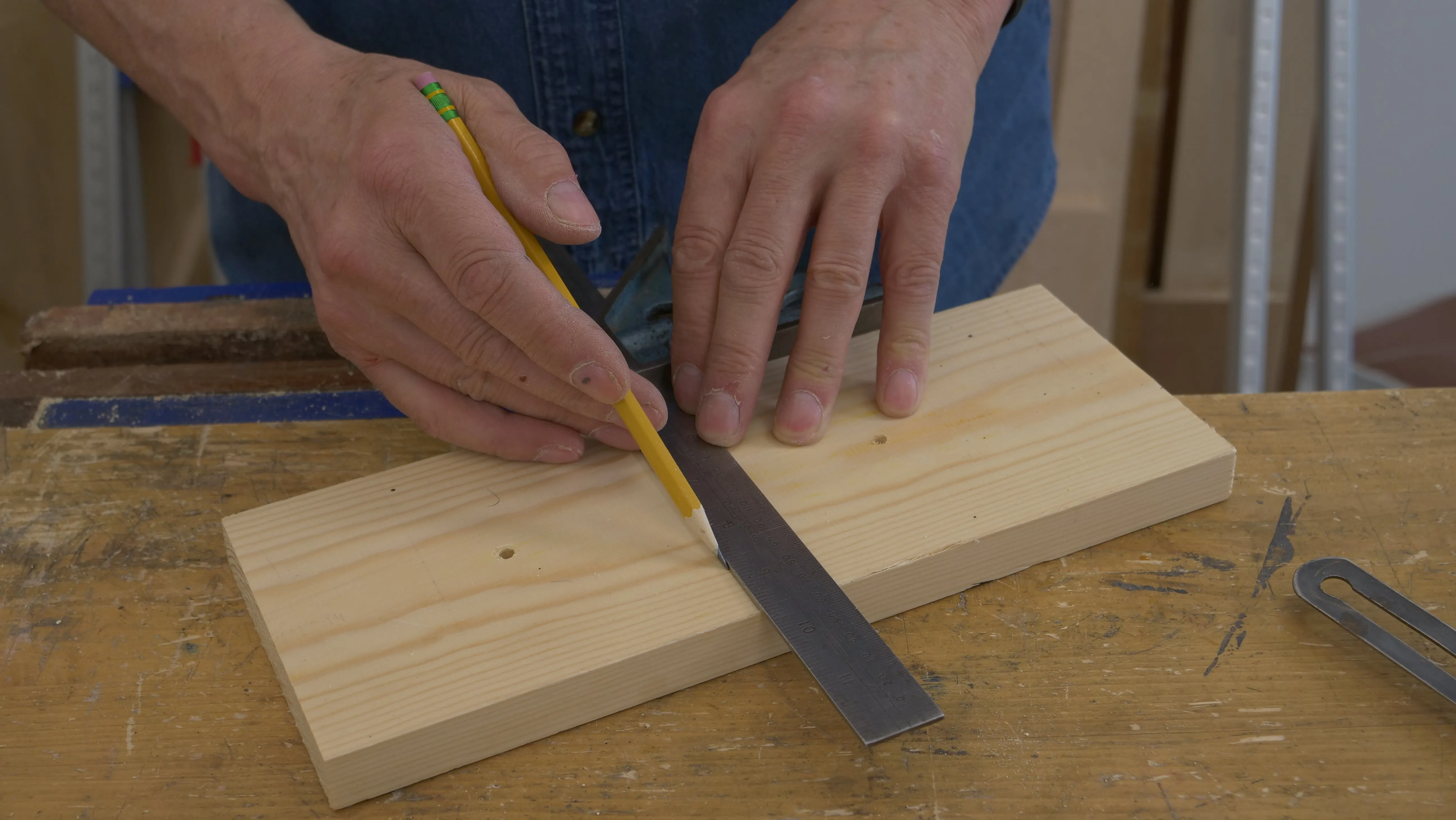 Square a line across a scrap piece of wood