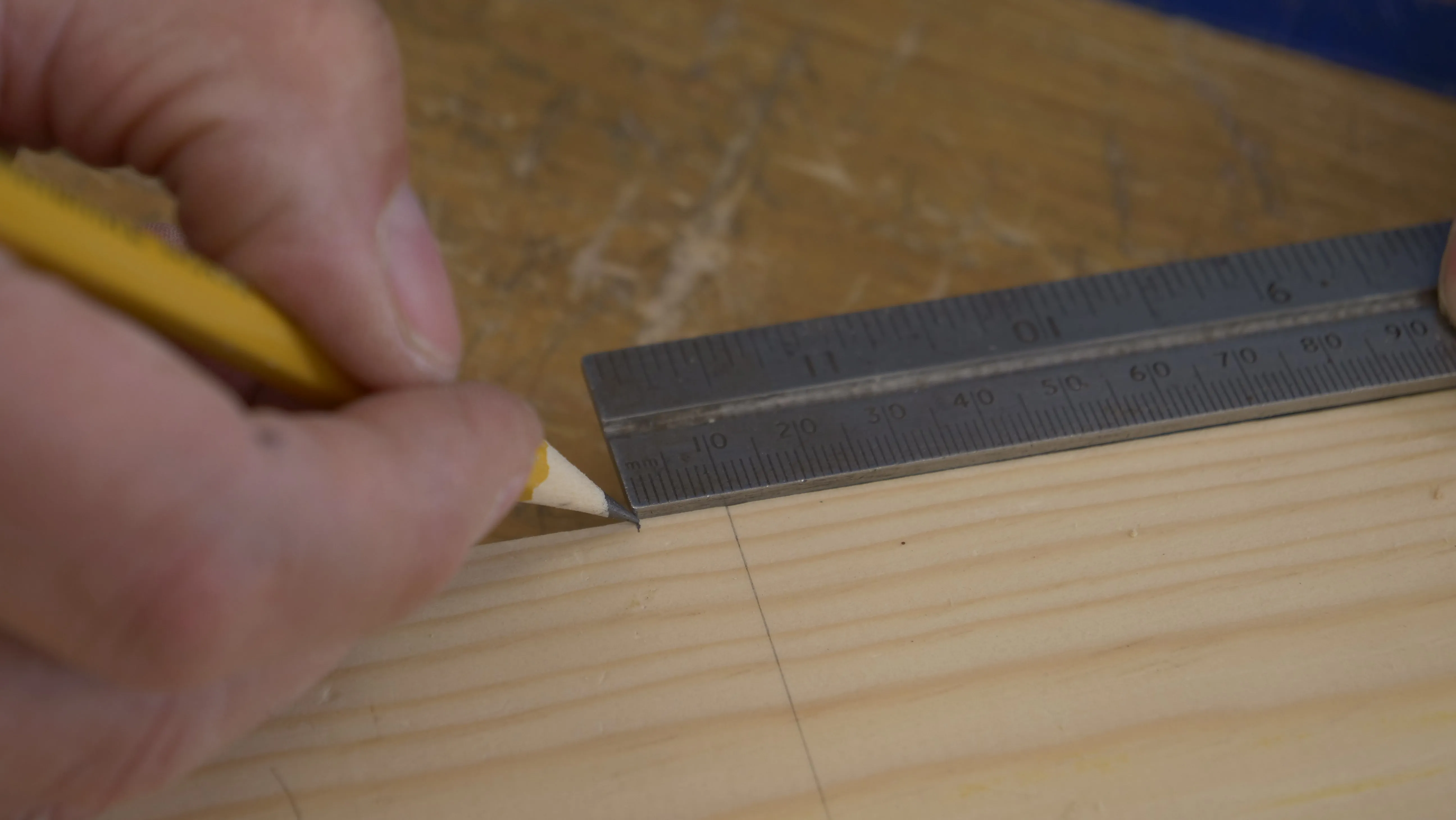 Measure one increment (10mm) to the side along the edge