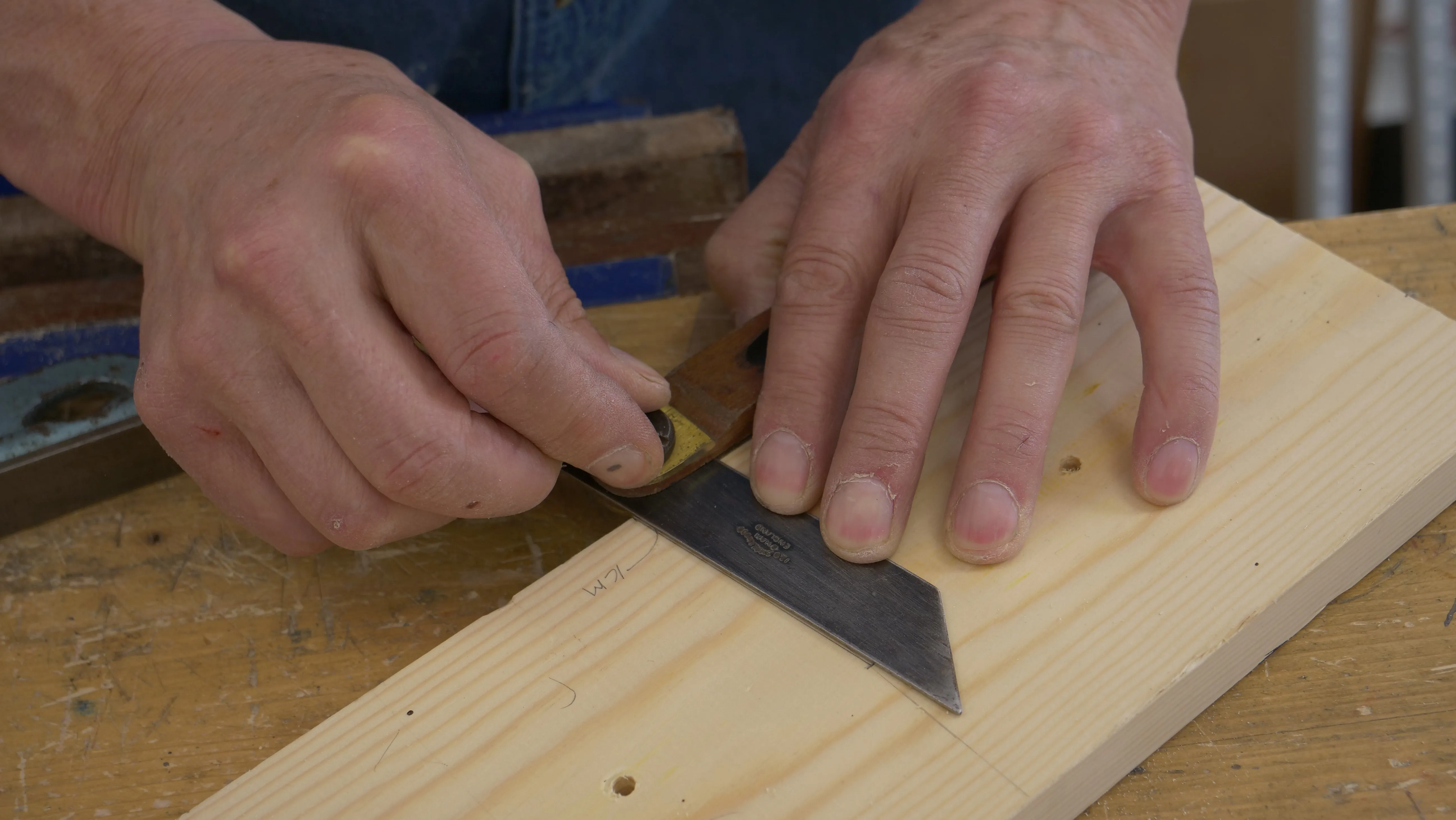 Register your sliding bevel against the edge. Adjust the beam to match the angled line and lock the nut tight.
