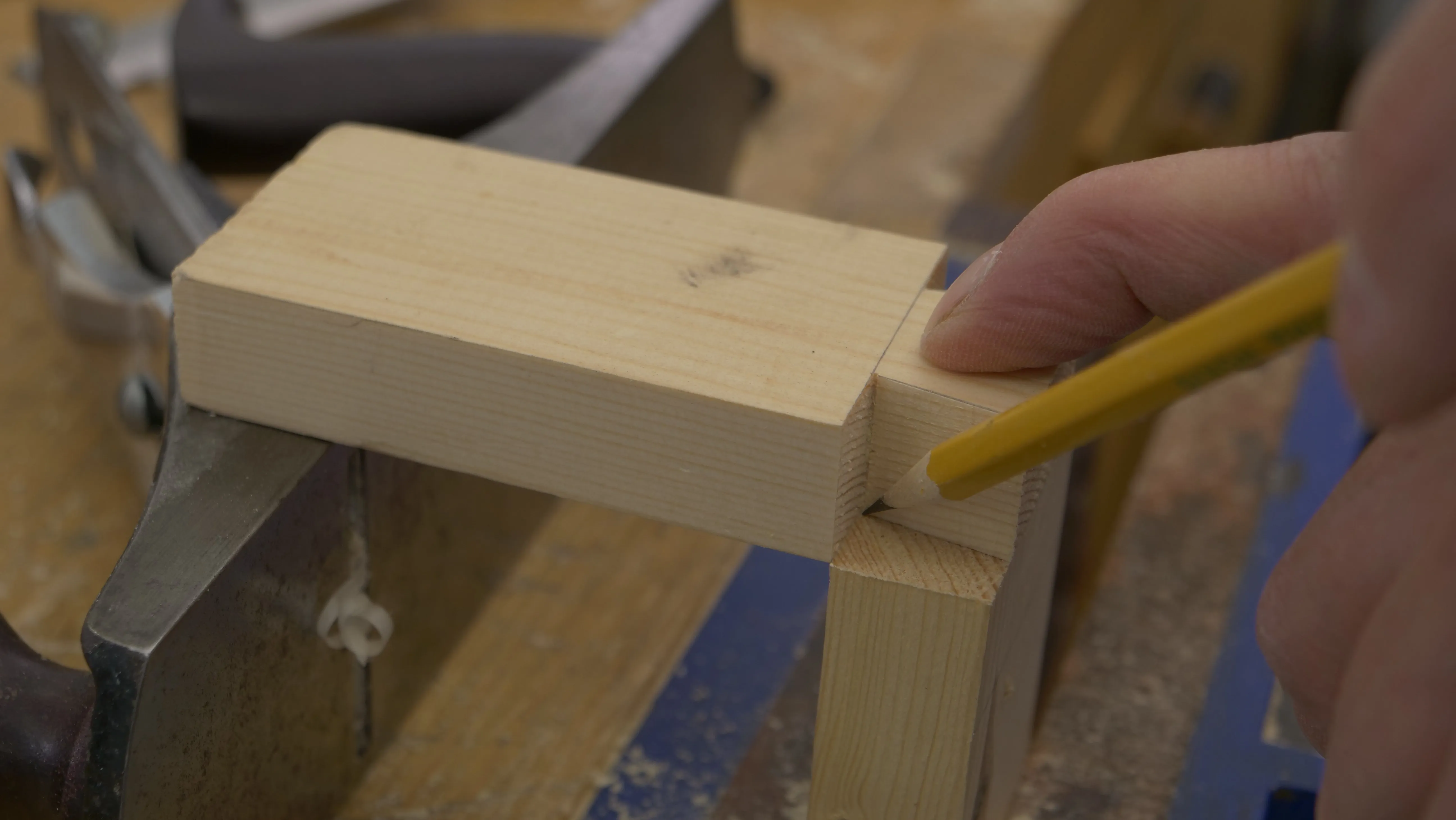 Pressing down on the tail piece to avoid slipping, mark the sides of the tail with a sharp, pointed pencil