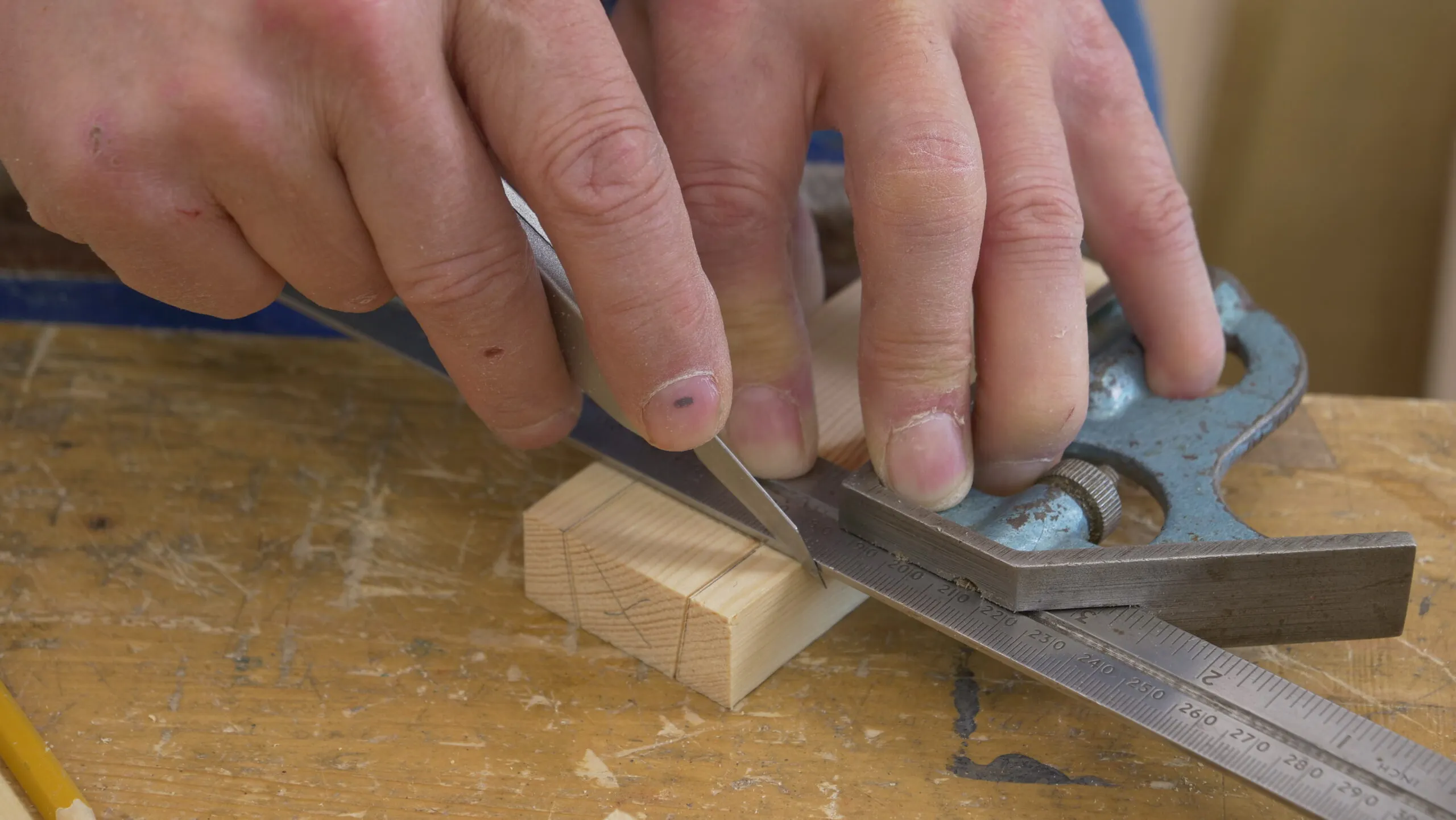 Without moving your square, make a very light knife nick on the corner