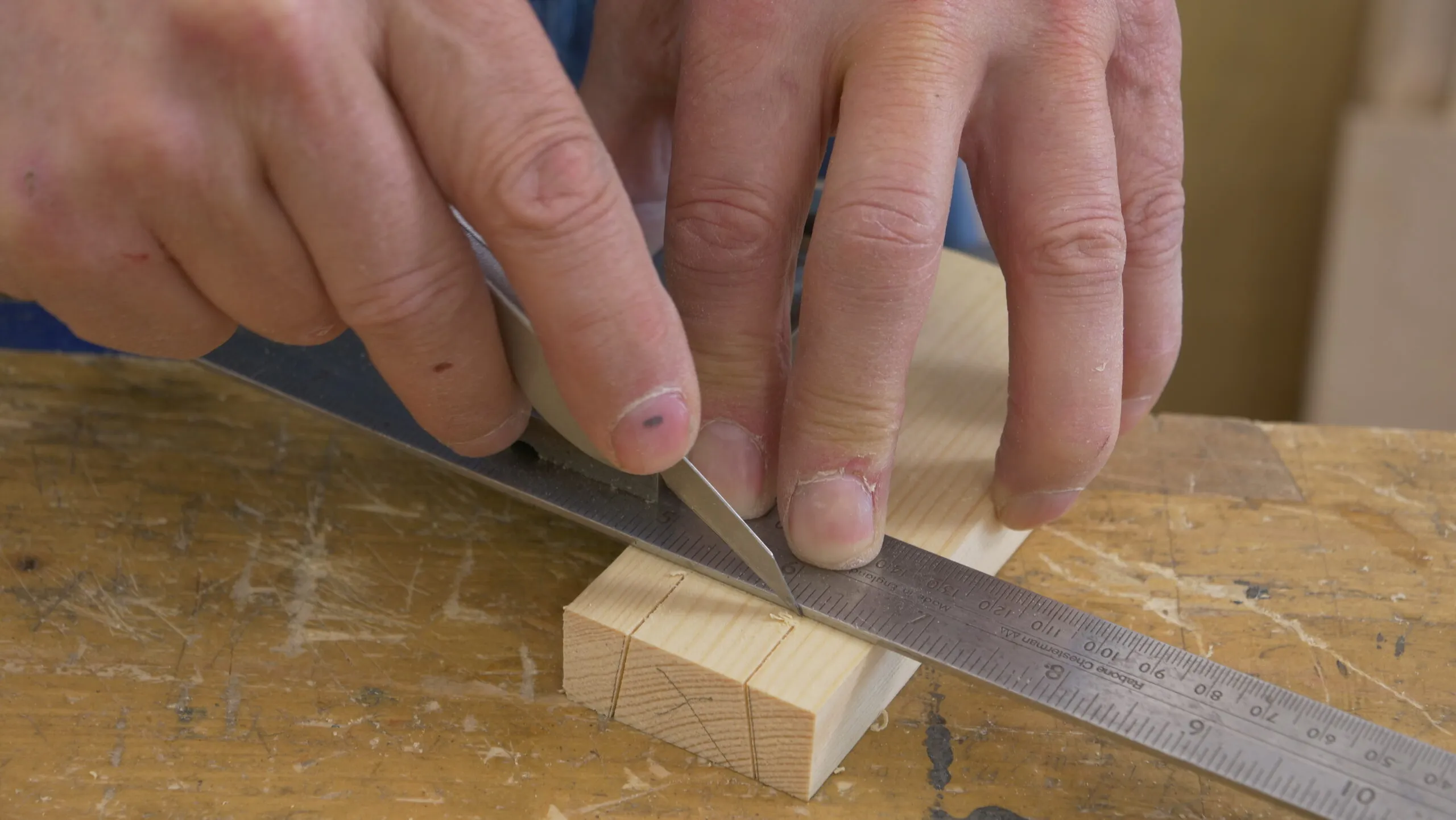 Use the second knife nick to register the square and make a second knifewall between the saw cuts on the opposite face