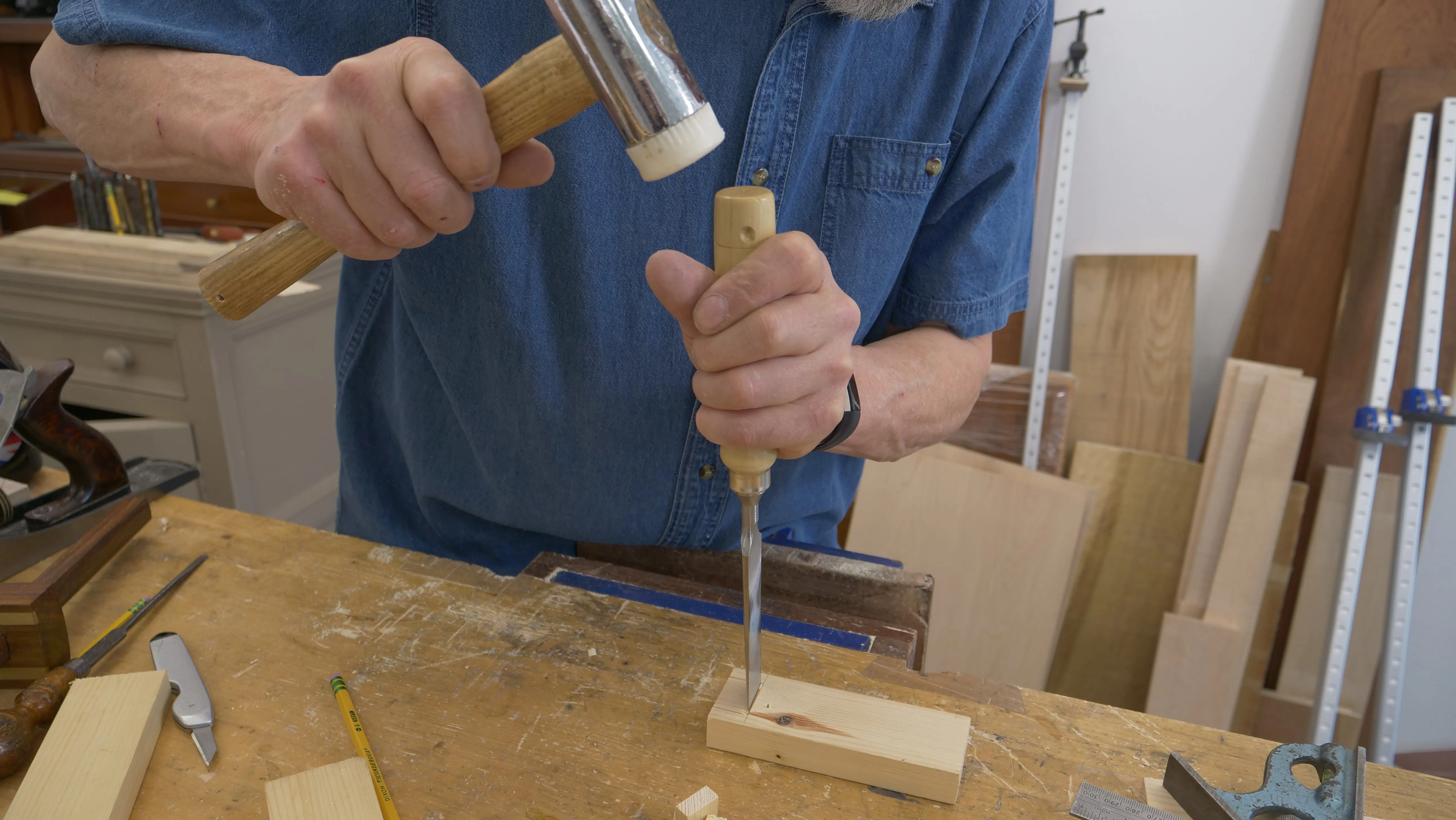 Using the widest chisel that will fit, place the flat face right up against the shoulder line and chop, not too hard